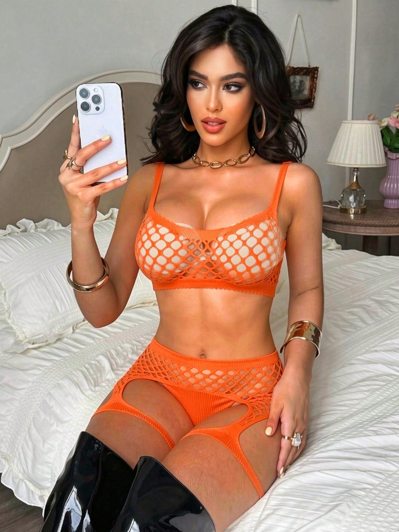 Black 2-piece fishnet lingerie set featuring a sheer wireless bralette with spaghetti straps and matching mini shorts with hollow-out detail; high-stretch fabric in a plain pattern.
