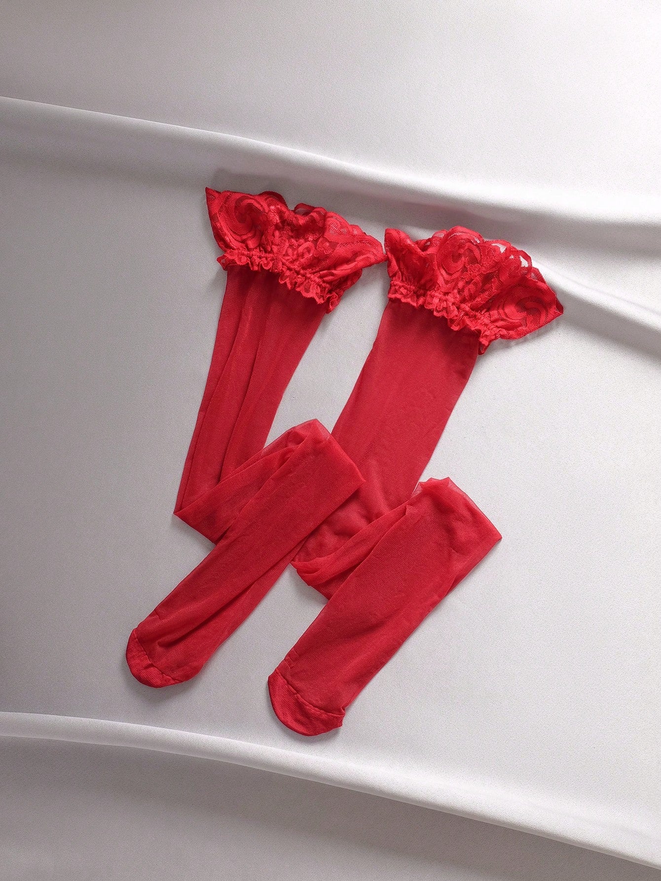 Three-piece lingerie set featuring a wireless spaghetti-strap bra with zipper and contrast lace splice details, a high-rise thong panty, and matching stockings in a punk-inspired style.