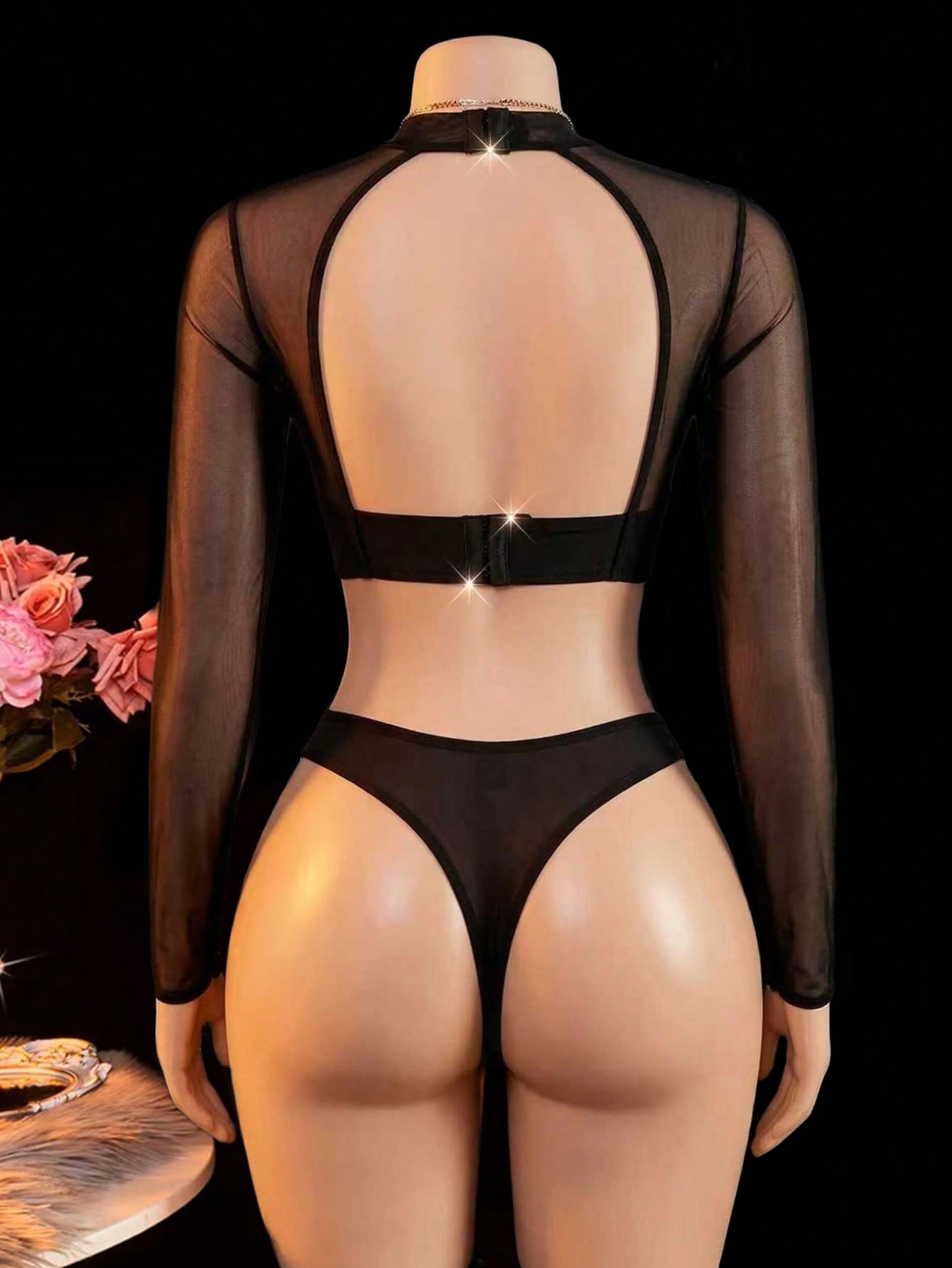 Black sheer lingerie set with a long sleeve cut-out top, thong panty, and matching stockings; includes adjustable spaghetti straps, triangle cups, underwire support, and slight stretch fabric.