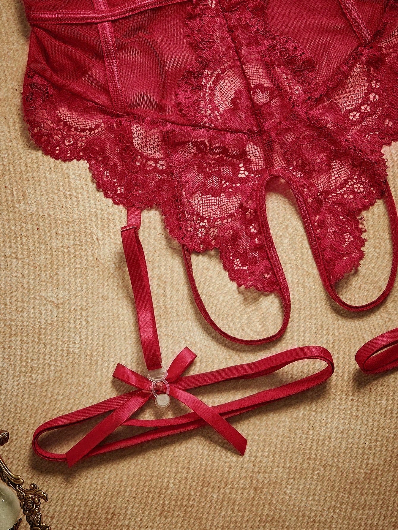 4-piece women’s lingerie set featuring a lace contrast mesh bodysuit with underwire, cut-out details, adjustable spaghetti straps, matching thong, and leg garters.