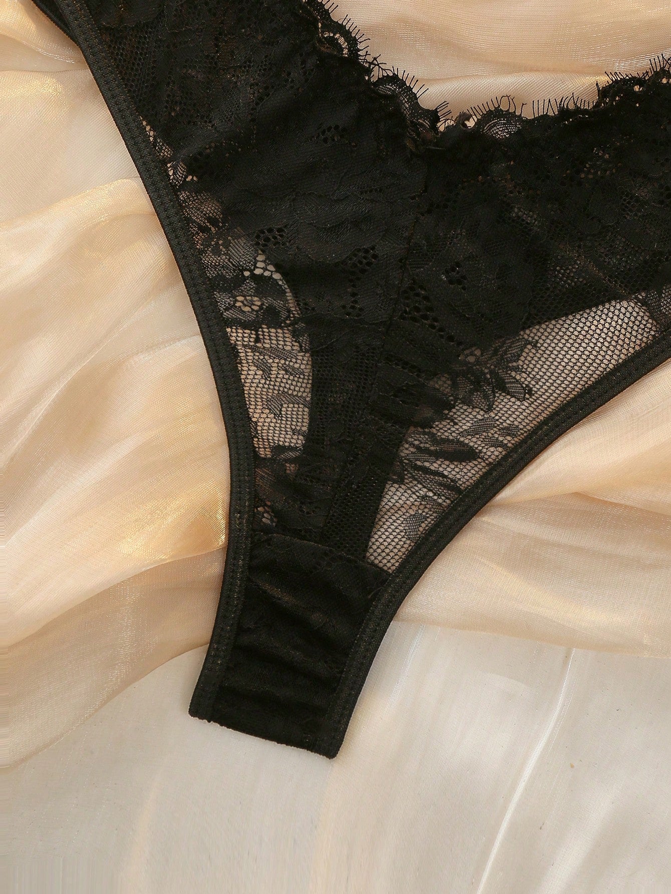 Dark green women’s lace teddy bodysuit set featuring spaghetti straps, backless criss-cross detailing, cut-out accents, and a thong-style high-rise bottom; semi-sheer lace with adjustable straps and wireless bralette support.