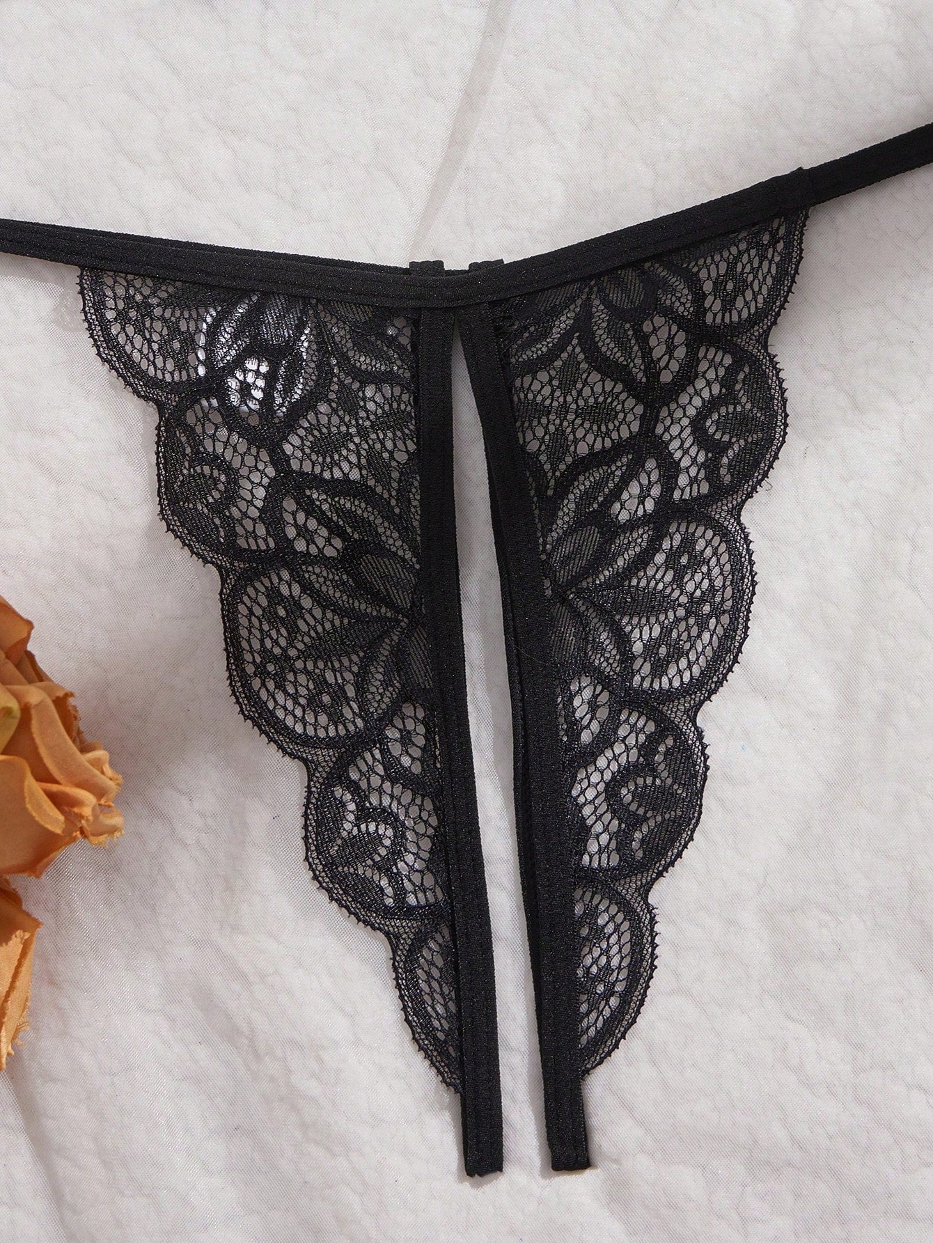Two-piece women’s sexy lingerie set with a wireless bralette and T-back V-string panties, featuring bowknot decoration, hollow-out detailing, and contrast lace accents with adjustable spaghetti straps.