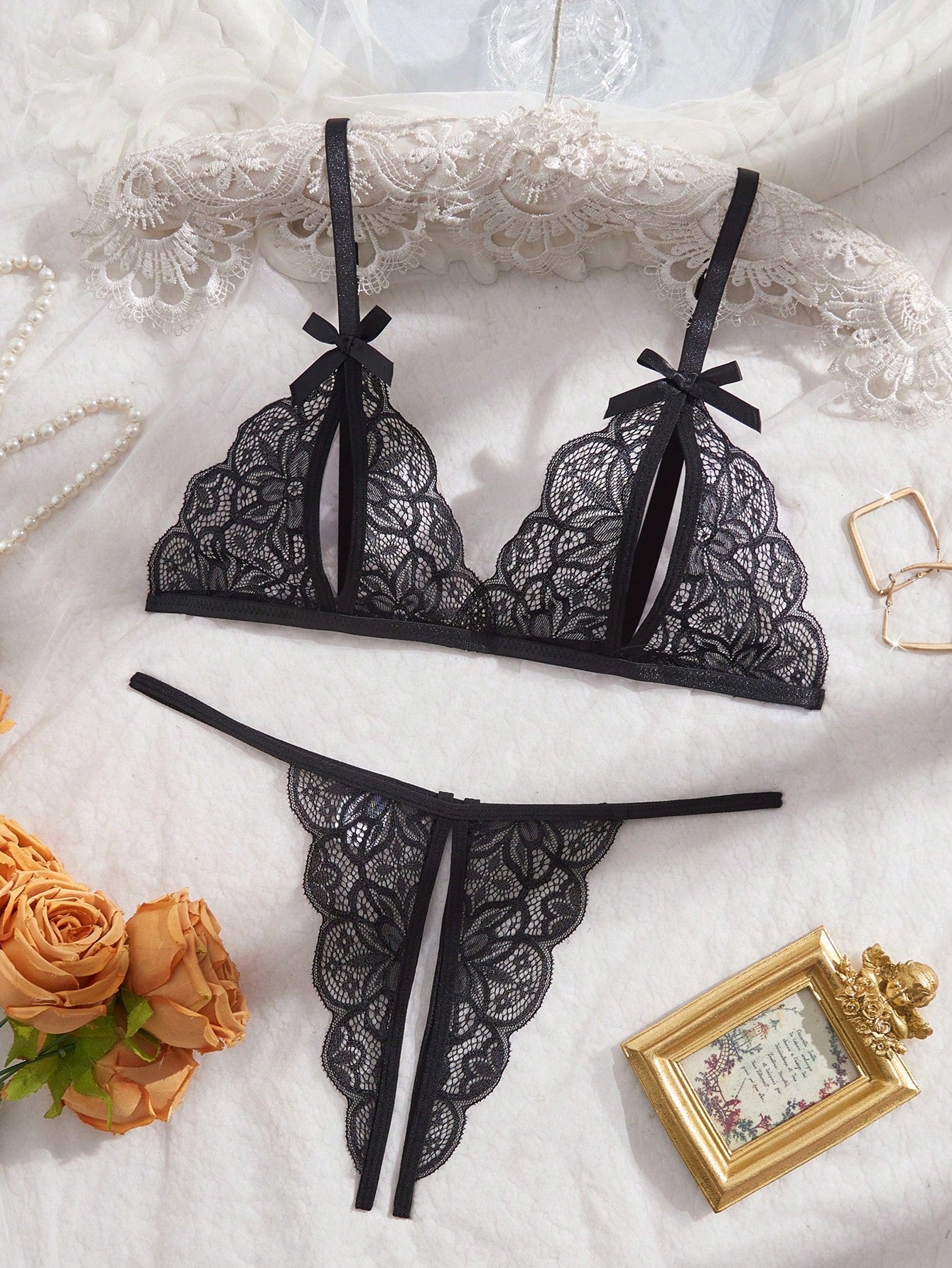 Two-piece floral lace cut-out lingerie set featuring a spaghetti strap bralette with adjustable straps and a matching low-rise V-string panty.