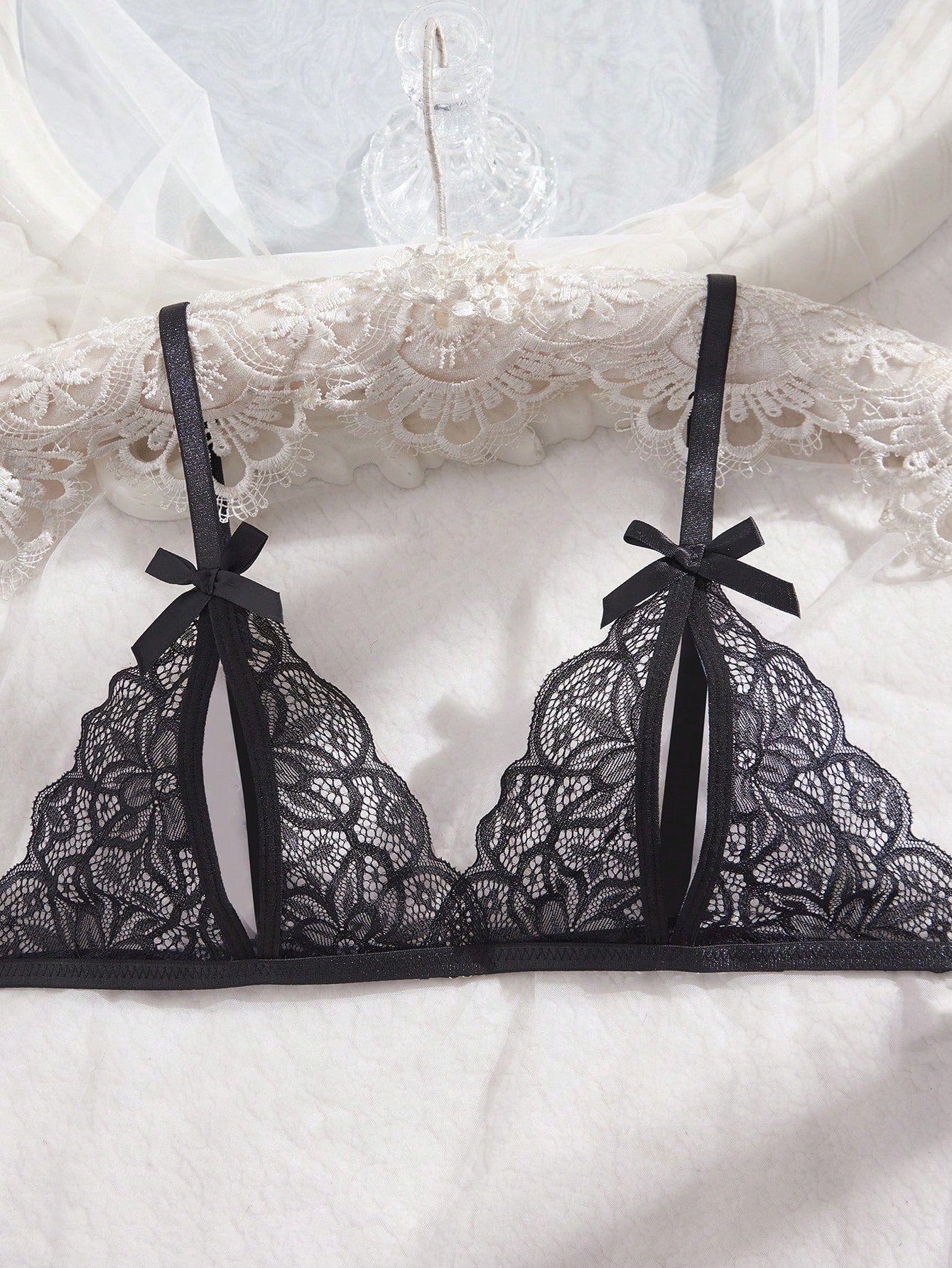 Two-piece women’s sexy lingerie set with a wireless bralette and T-back V-string panties, featuring bowknot decoration, hollow-out detailing, and contrast lace accents with adjustable spaghetti straps.