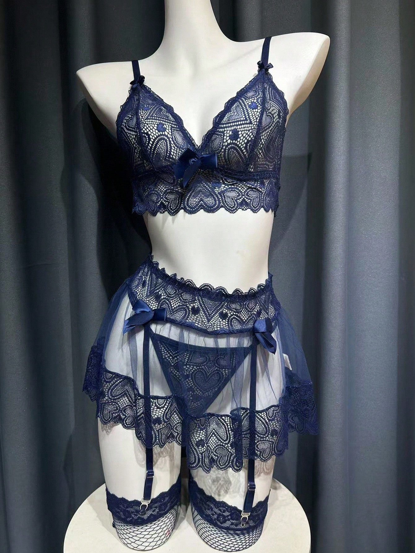 Women’s 5-piece sexy lingerie set featuring contrast lace and mesh details, including a wireless bra with adjustable spaghetti straps, a low-rise G-string thong, a short skirt, and two mesh stockings.