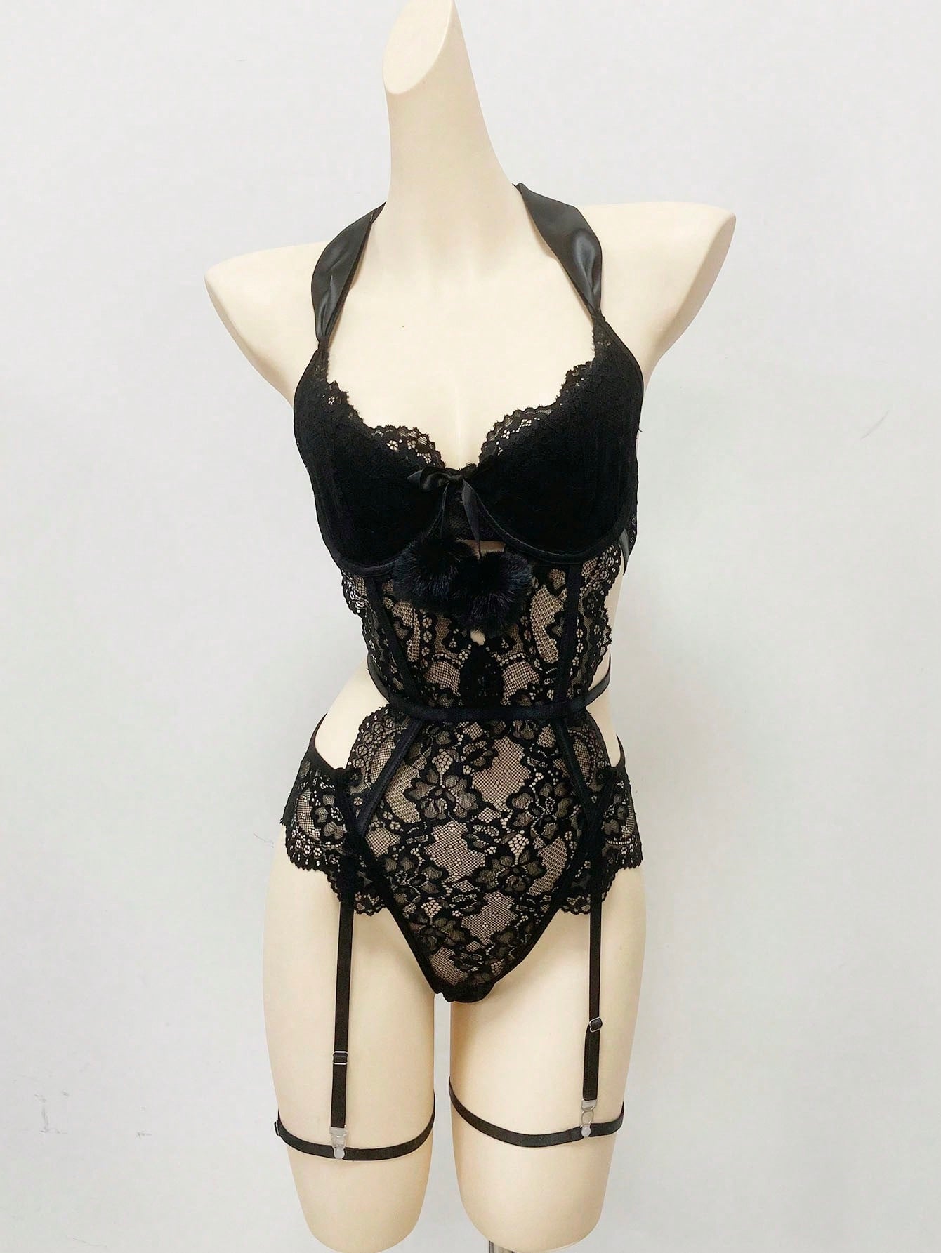 Black women's lace bowknot decorated lingerie set featuring a sleeveless spaghetti strap bodysuit with underwire, cut-out and scallop details, plus matching low-rise thong pieces in a 3-piece set.