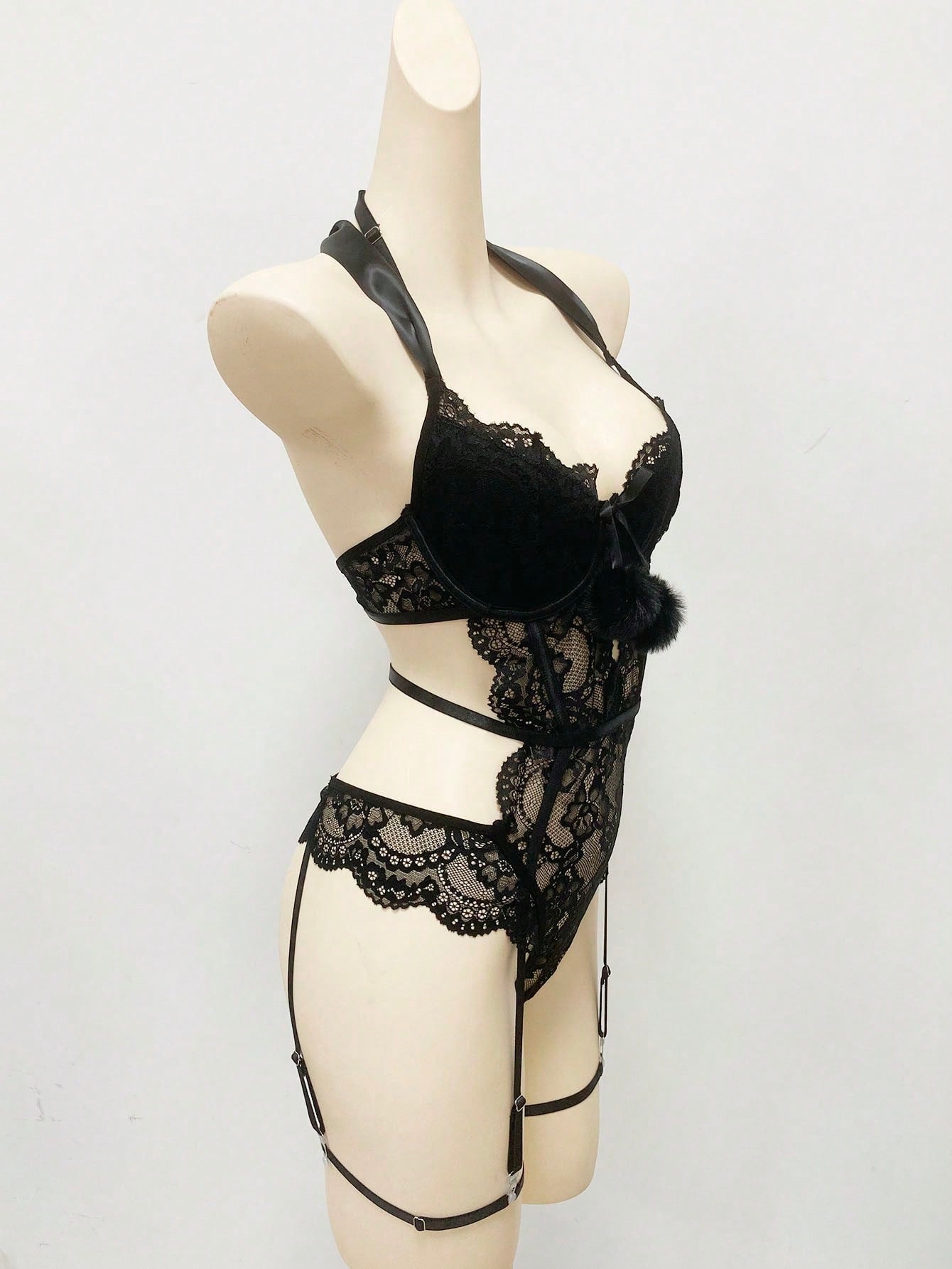 Black women's lace bowknot decorated lingerie set featuring a sleeveless spaghetti strap bodysuit with underwire, cut-out and scallop details, plus matching low-rise thong pieces in a 3-piece set.