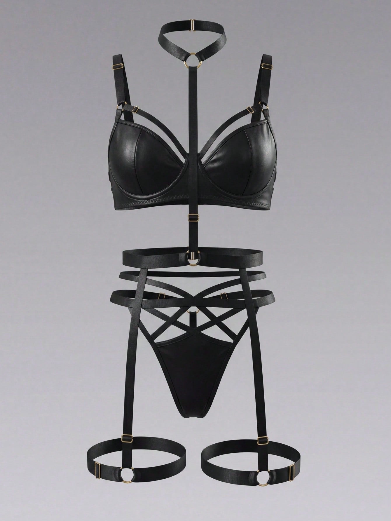 Black 3-piece goth lingerie set with adjustable spaghetti straps, underwire bralette, harness and ring details, cut-out garter design, and matching thong.