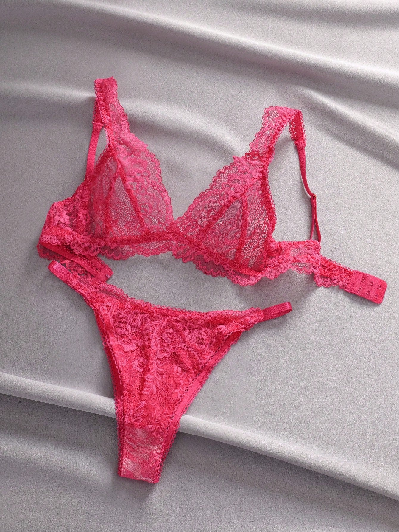 Women's floral lace lingerie set featuring a camisole-style wireless bra with adjustable straps and matching mid-rise briefs, designed with contrast scalloped lace and light support.