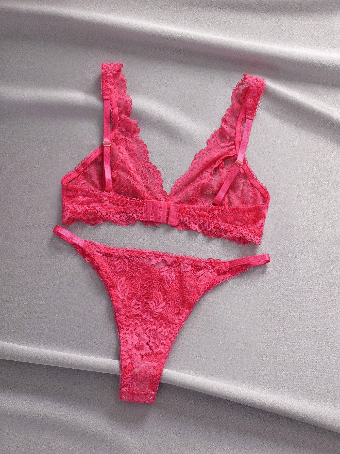 Women's floral lace lingerie set featuring a camisole-style wireless bra with adjustable straps and matching mid-rise briefs, designed with contrast scalloped lace and light support.