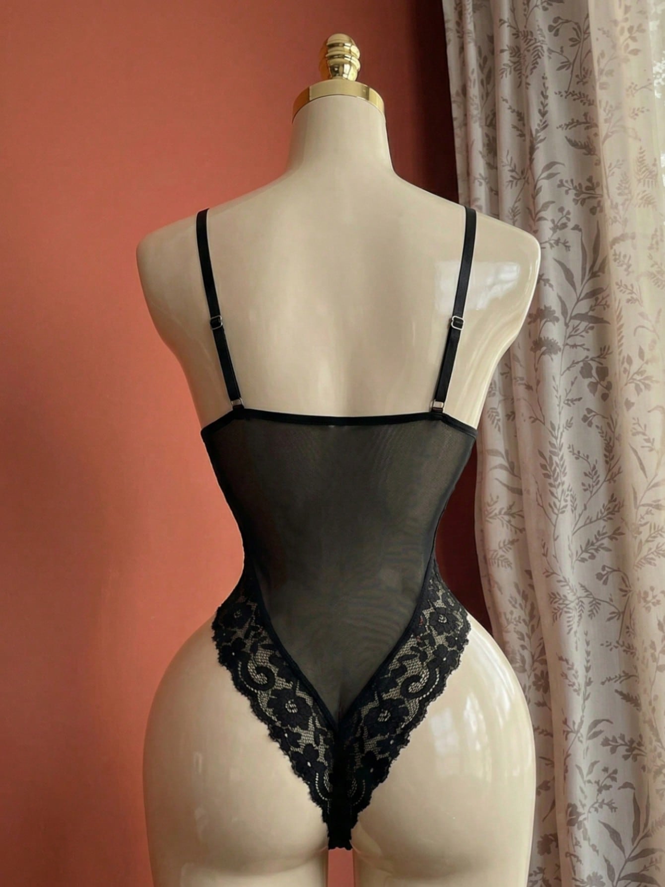 Black eyelash lace panel teddy bodysuit lingerie with sheer baroque pattern, spaghetti straps, triangle underwire bra, and thong back.