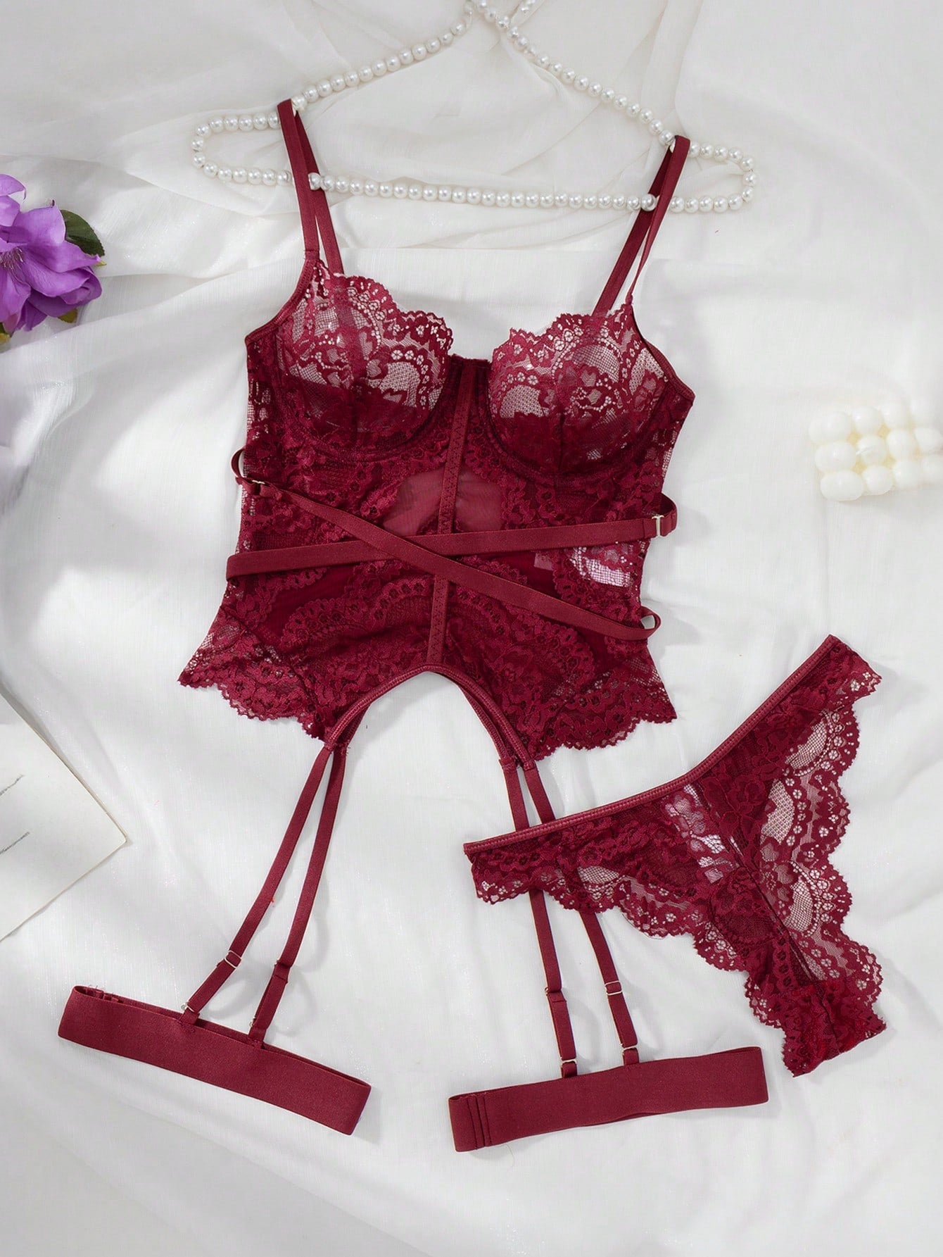 Women’s 4-piece lace lingerie set featuring a longline underwire bra with adjustable spaghetti straps, matching low-rise thong panties, and decorative ribbon details with cutout accents.