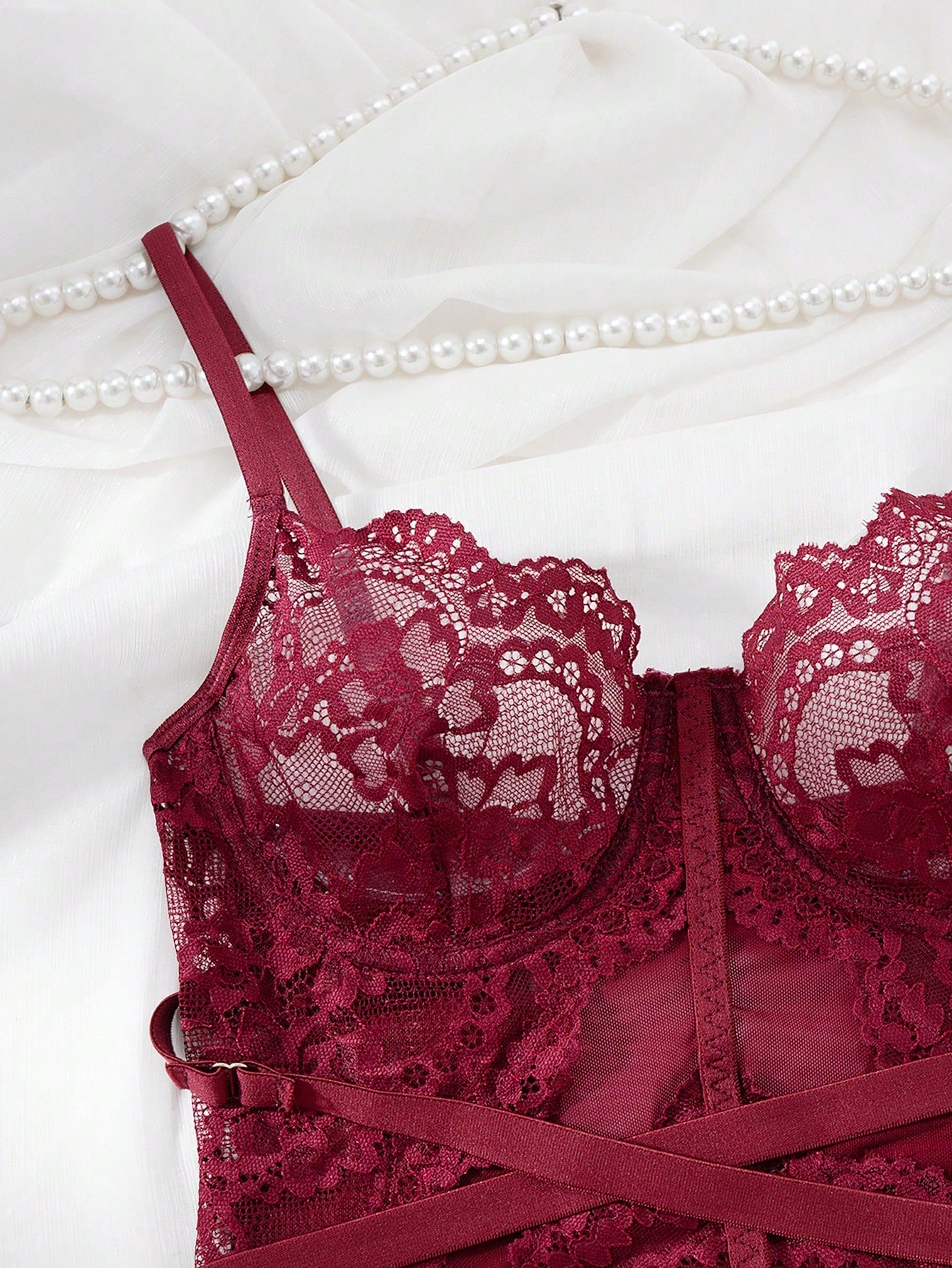 Women’s 4-piece lace lingerie set featuring a longline underwire bra with adjustable spaghetti straps, matching low-rise thong panties, and decorative ribbon details with cutout accents.