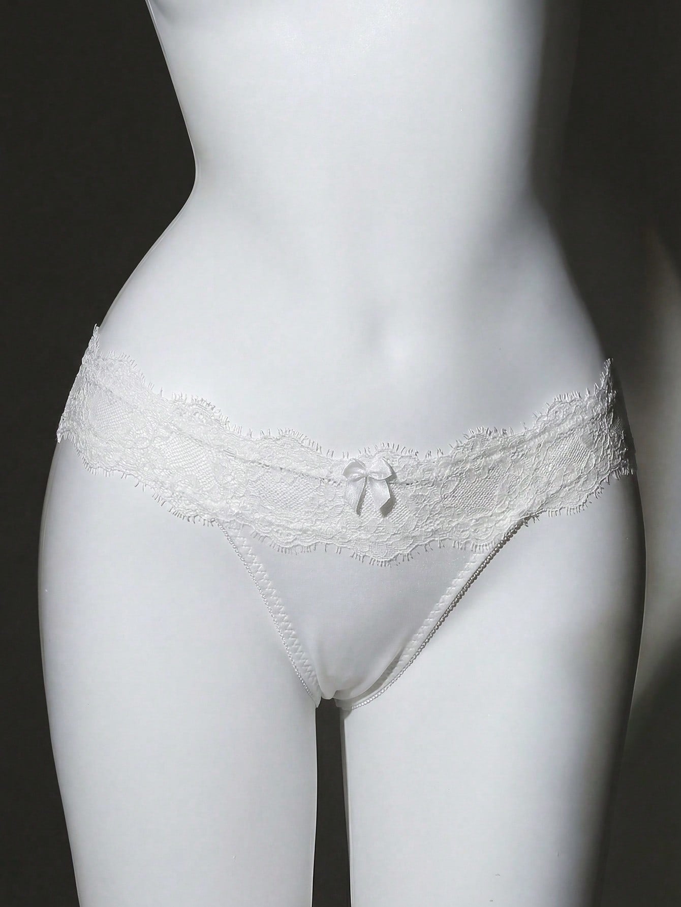 Women's low-rise lace briefs with bow detail, hollow-out patchwork, and Christmas pattern