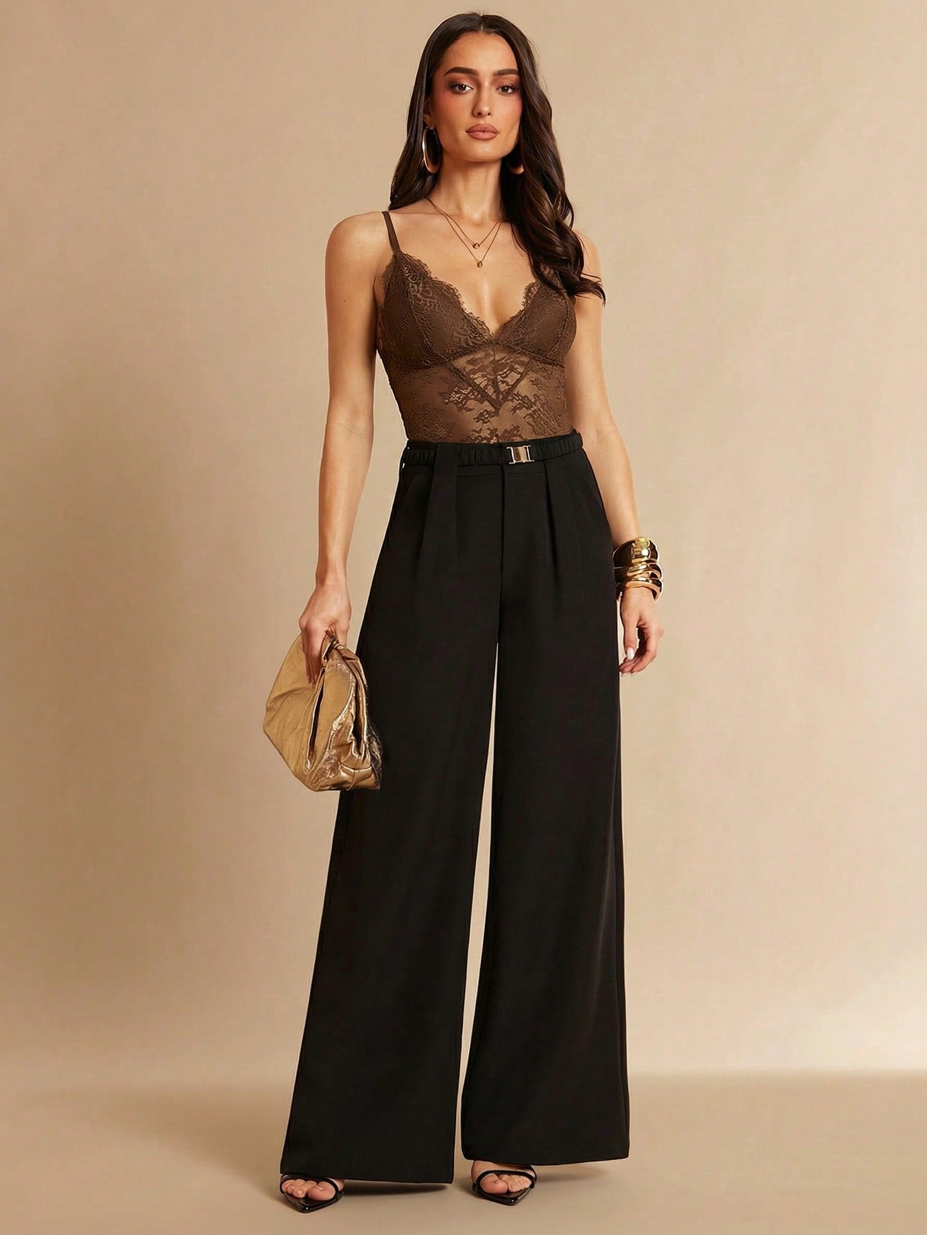Women's black bodysuit with lace trim, sheer details, backless design, and spaghetti straps in a slim-fit cami style.