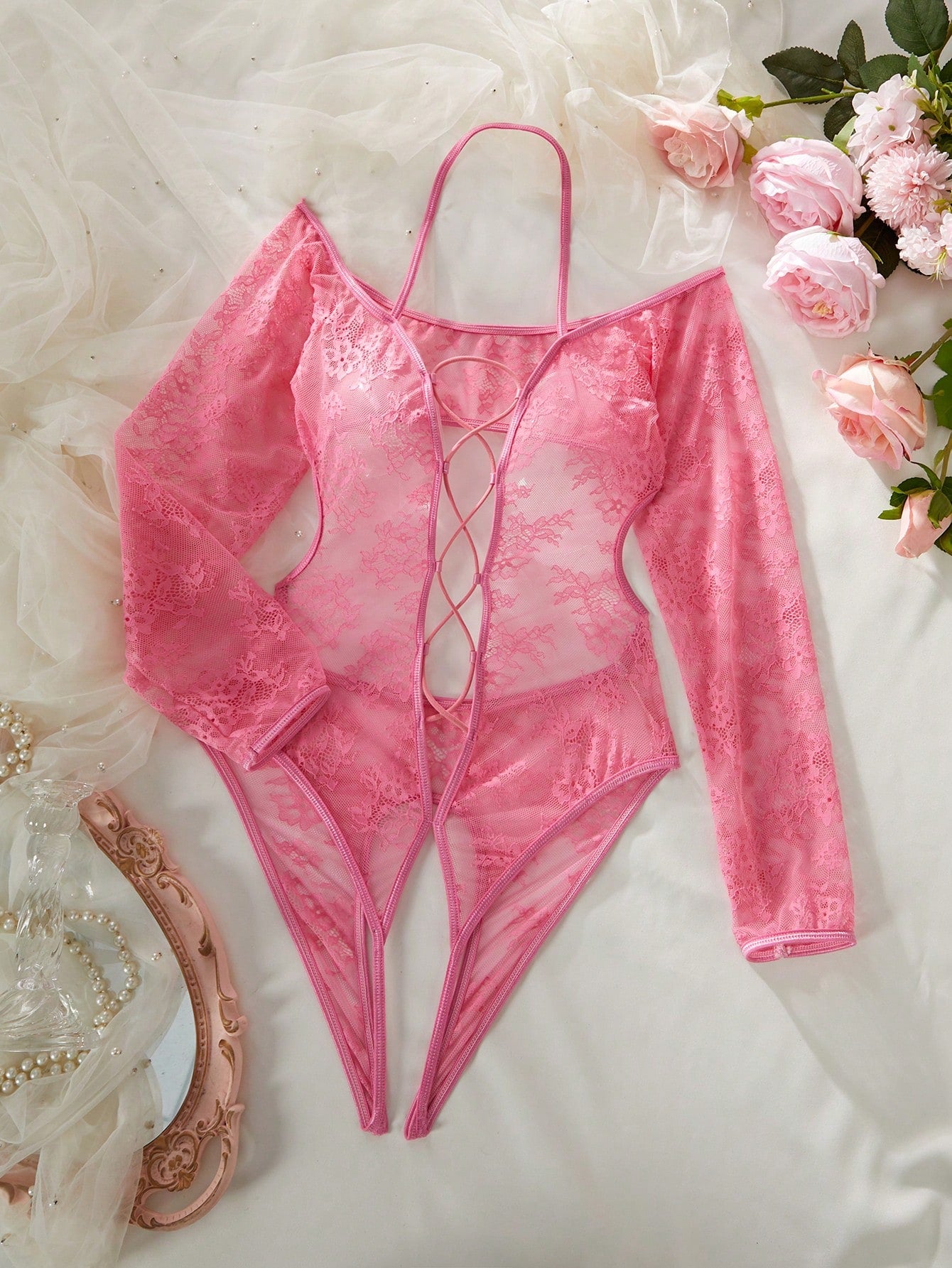Elegant lace crotchless bodysuit with a backless lace-up design, adjustable spaghetti straps, and a V-string style bottom.