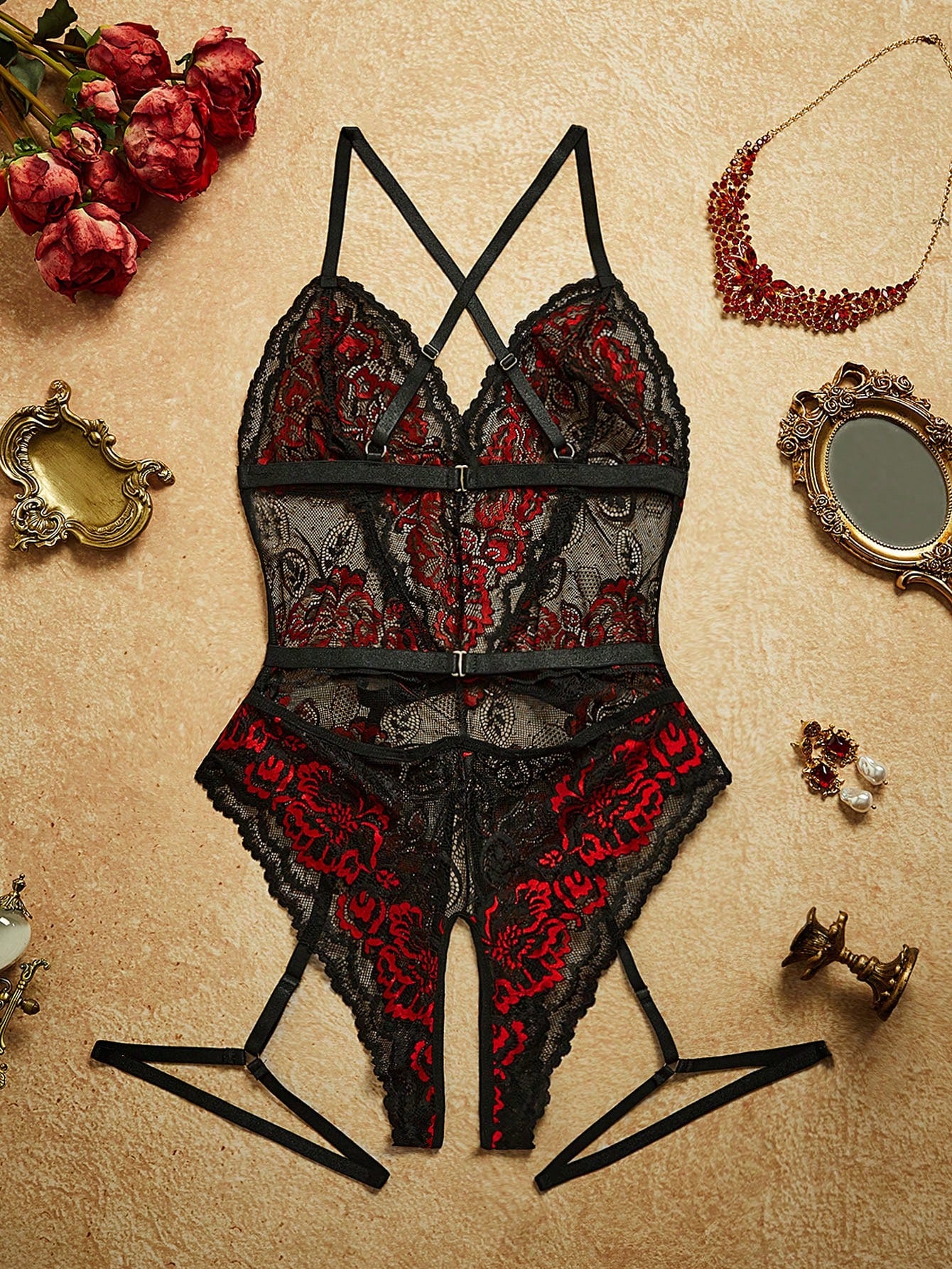 Two-piece women’s sexy lace bodysuit set with contrast lace, cut-out and sheer details, spaghetti straps, crossback design, sleeveless fit, and thong-style bottoms; wireless style for going-out or private party wear.