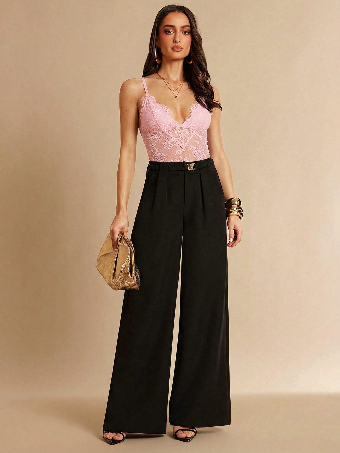 Women's black bodysuit with lace trim, sheer details, backless design, and spaghetti straps in a slim-fit cami style.