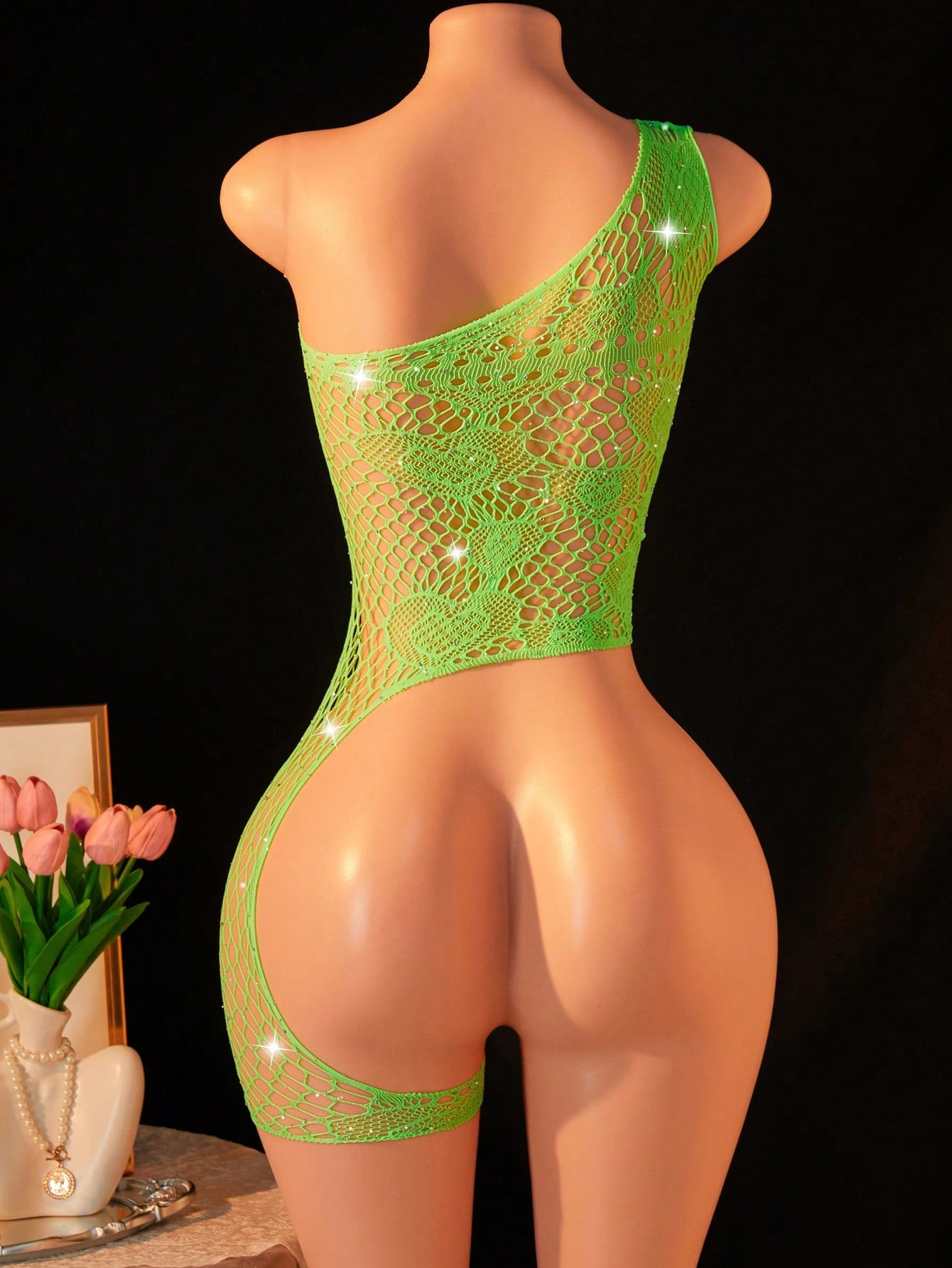 Women's asymmetric sexy lingerie teddy bodysuit with one-shoulder design, rhinestone detail, fishnet fabric, bow accents, and hollow-out styling for nightwear.