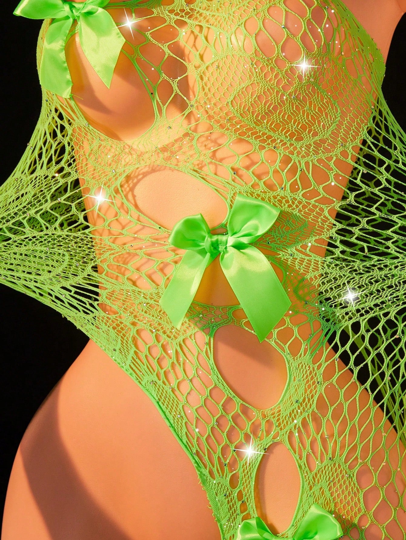 Women's asymmetric sexy lingerie teddy bodysuit with one-shoulder design, rhinestone detail, fishnet fabric, bow accents, and hollow-out styling for nightwear.