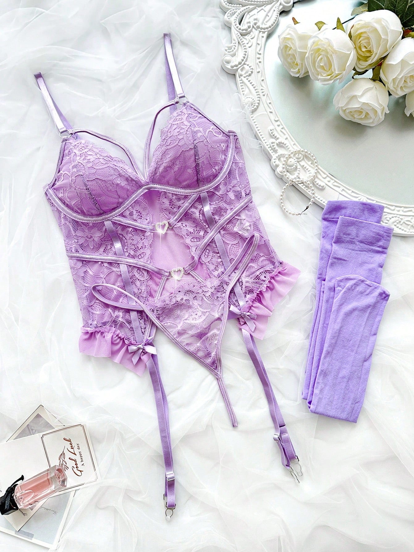 Purple 4-piece lingerie set with romantic lace patchwork, underwire longline bra with adjustable spaghetti straps and full cups, matching low-rise thong, and bow and cut-out details.