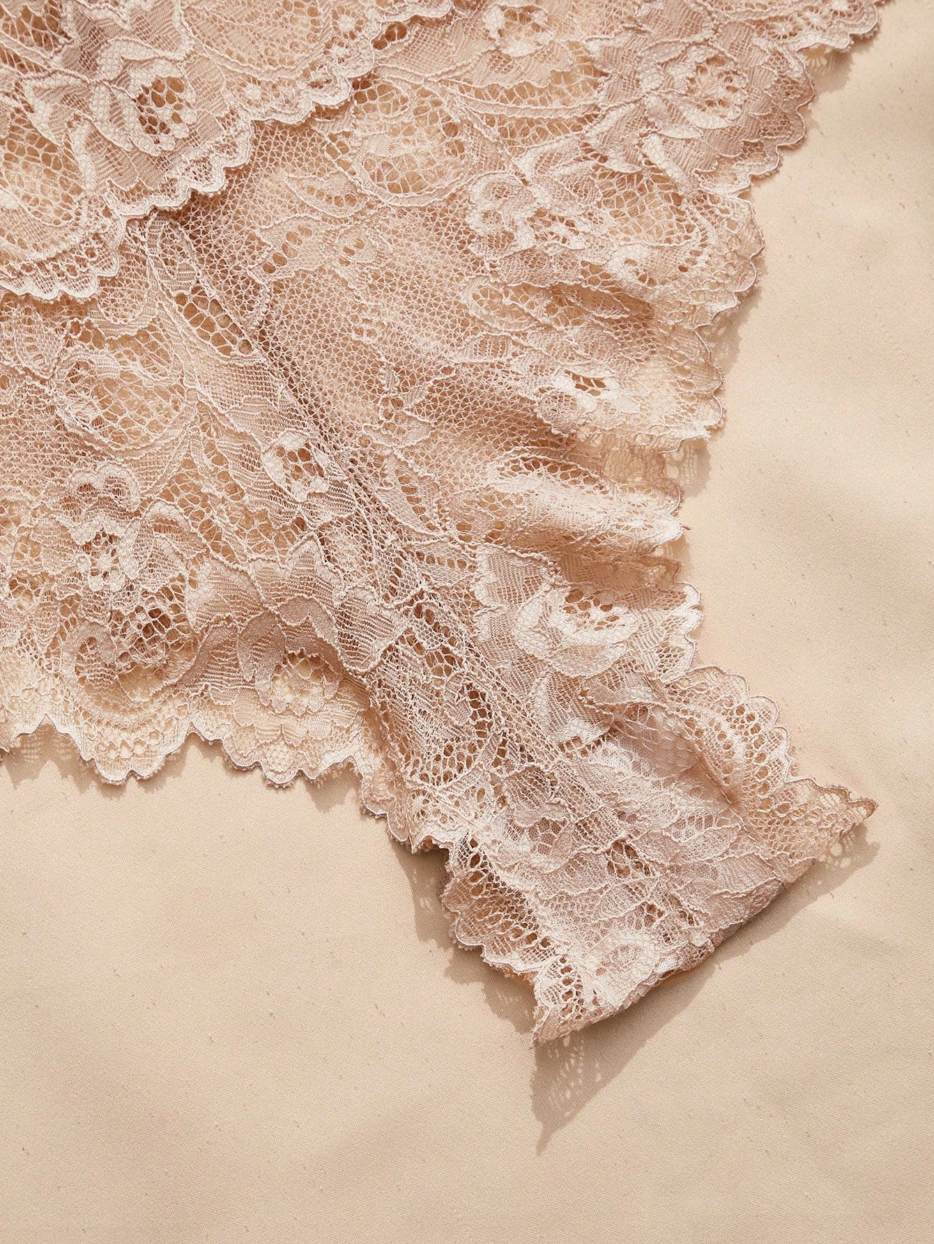Women's black lace bodysuit with sheer contrast lace, backless design, spaghetti straps, and adjustable straps