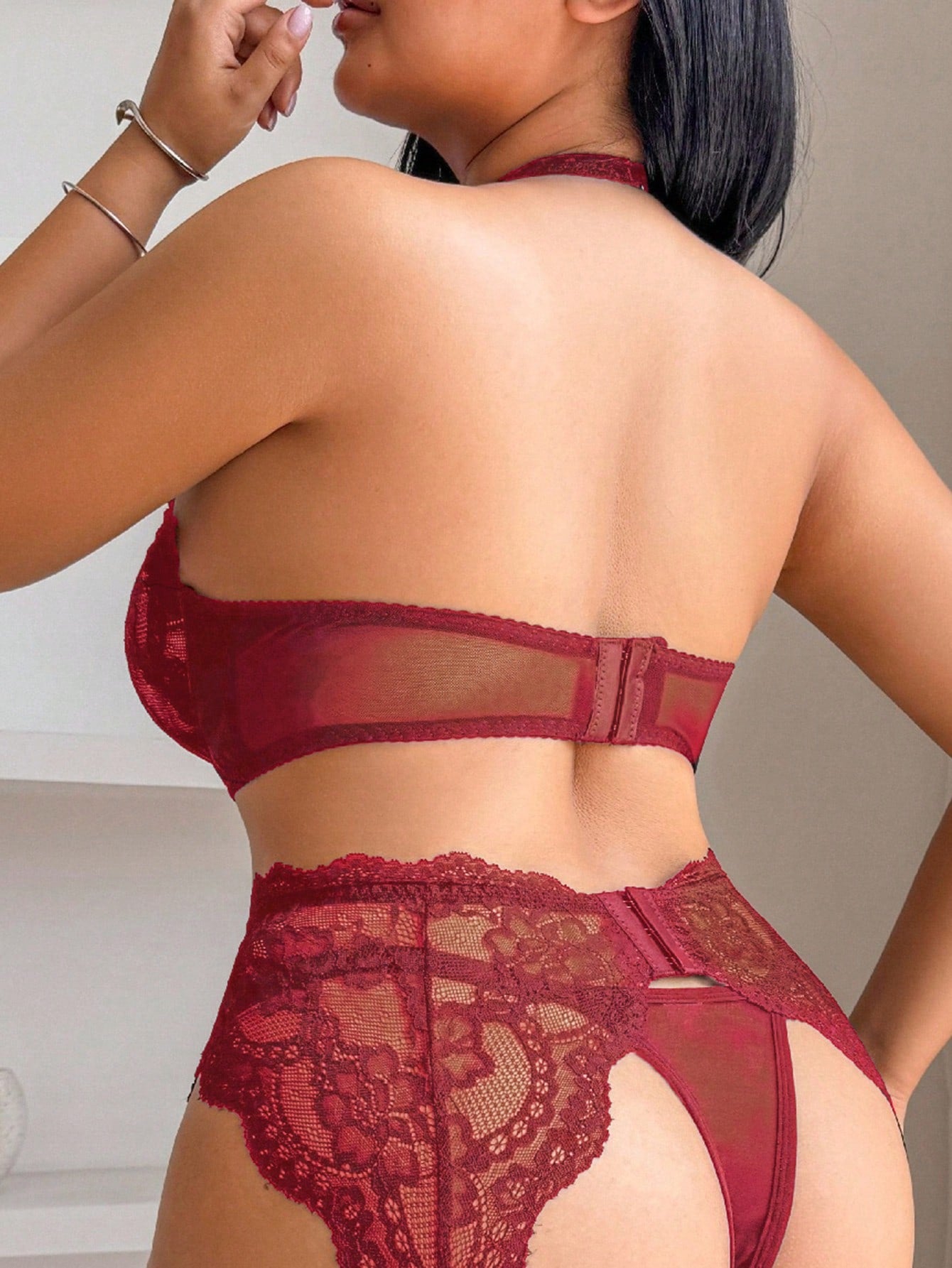 Plus size 5-piece lace lingerie set featuring a halter underwire top with adjustable straps, garter belt, thong-style G-string, and one pair of thigh-high fishnet stockings.
