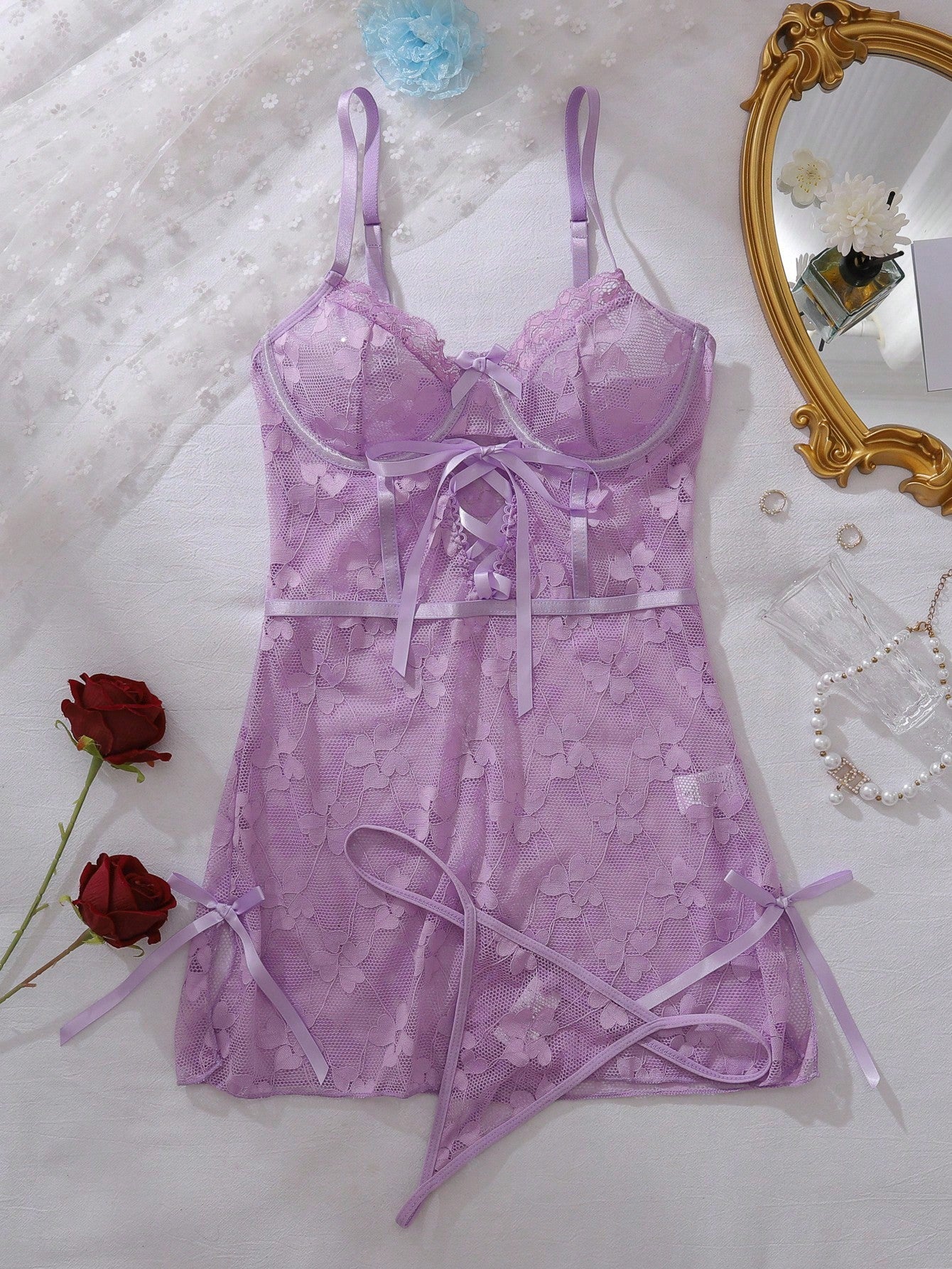 Purple romantic lingerie 2-piece set featuring a short lace-up underwire dress with spaghetti straps, bow detail, and matching low-rise thong panty.
