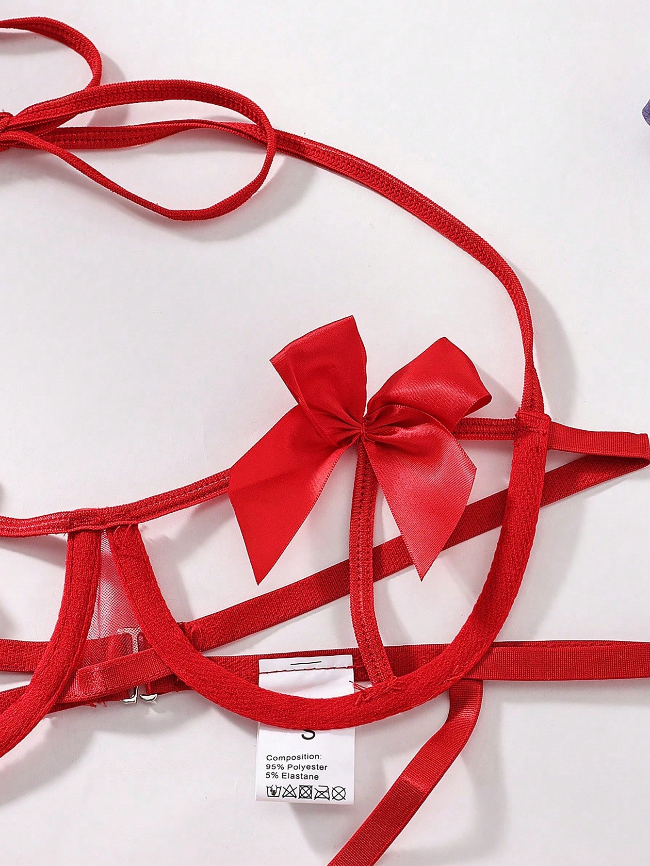 Red women’s sexy lingerie 3-piece set with bowknot detail and cut-out design, featuring a halter neckline, underwire full-cup top, adjustable straps, and matching high-rise thong bottoms; Valentine’s Day theme.