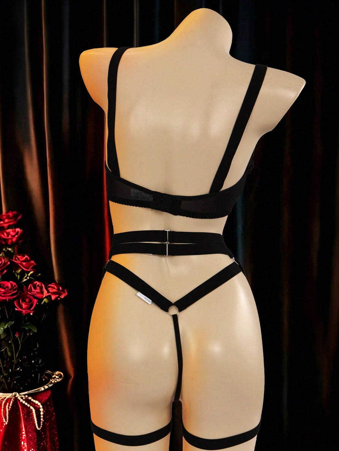 Black 5-piece women's sexy lingerie set with tie-up design, cut-out details, ring accents, adjustable straps, and low-rise thong bottoms in a plain pattern.