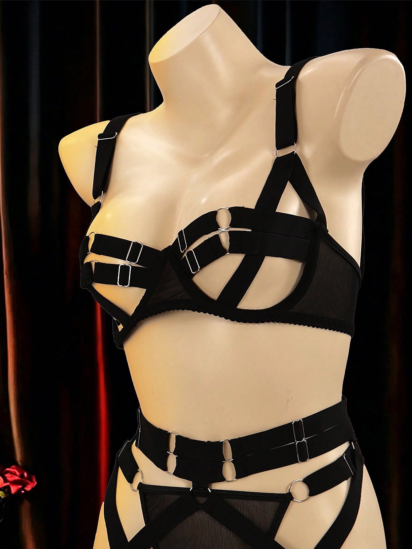 Black 5-piece women's sexy lingerie set with tie-up design, cut-out details, ring accents, adjustable straps, and low-rise thong bottoms in a plain pattern.
