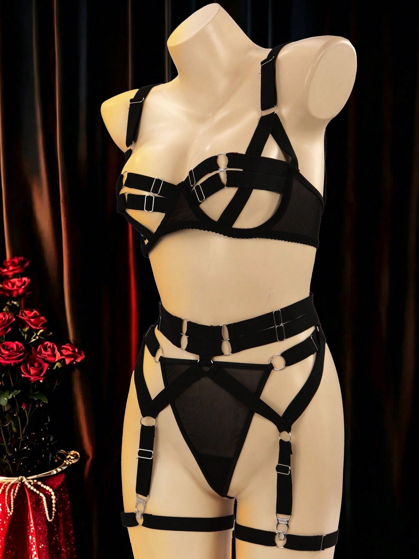 Black 5-piece women's sexy lingerie set with tie-up design, cut-out details, ring accents, adjustable straps, and low-rise thong bottoms in a plain pattern.
