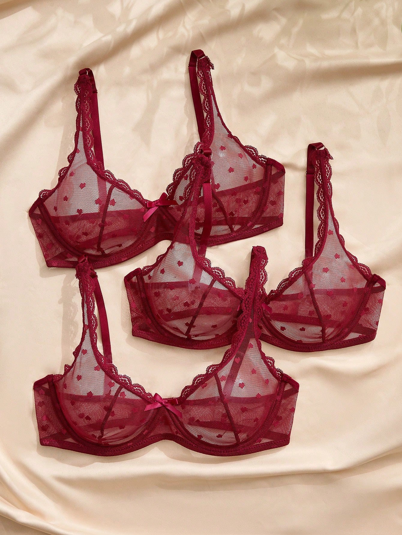 Women's solid color lace bra with sheer unlined design, bow detail, underwire support, and adjustable straps; romantic style push-up bralette for daily wear.