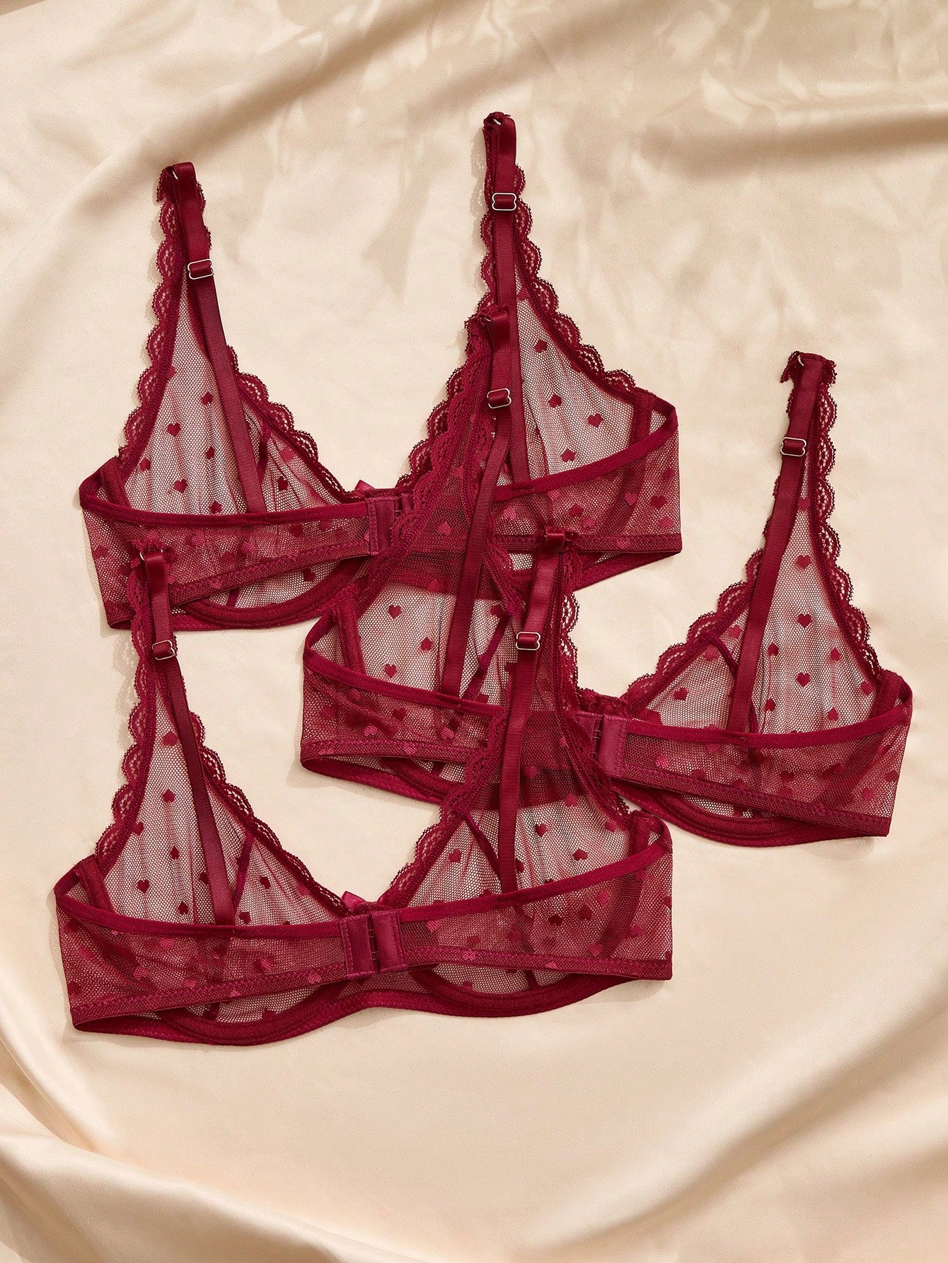 Women's solid color lace bra with sheer unlined design, bow detail, underwire support, and adjustable straps; romantic style push-up bralette for daily wear.