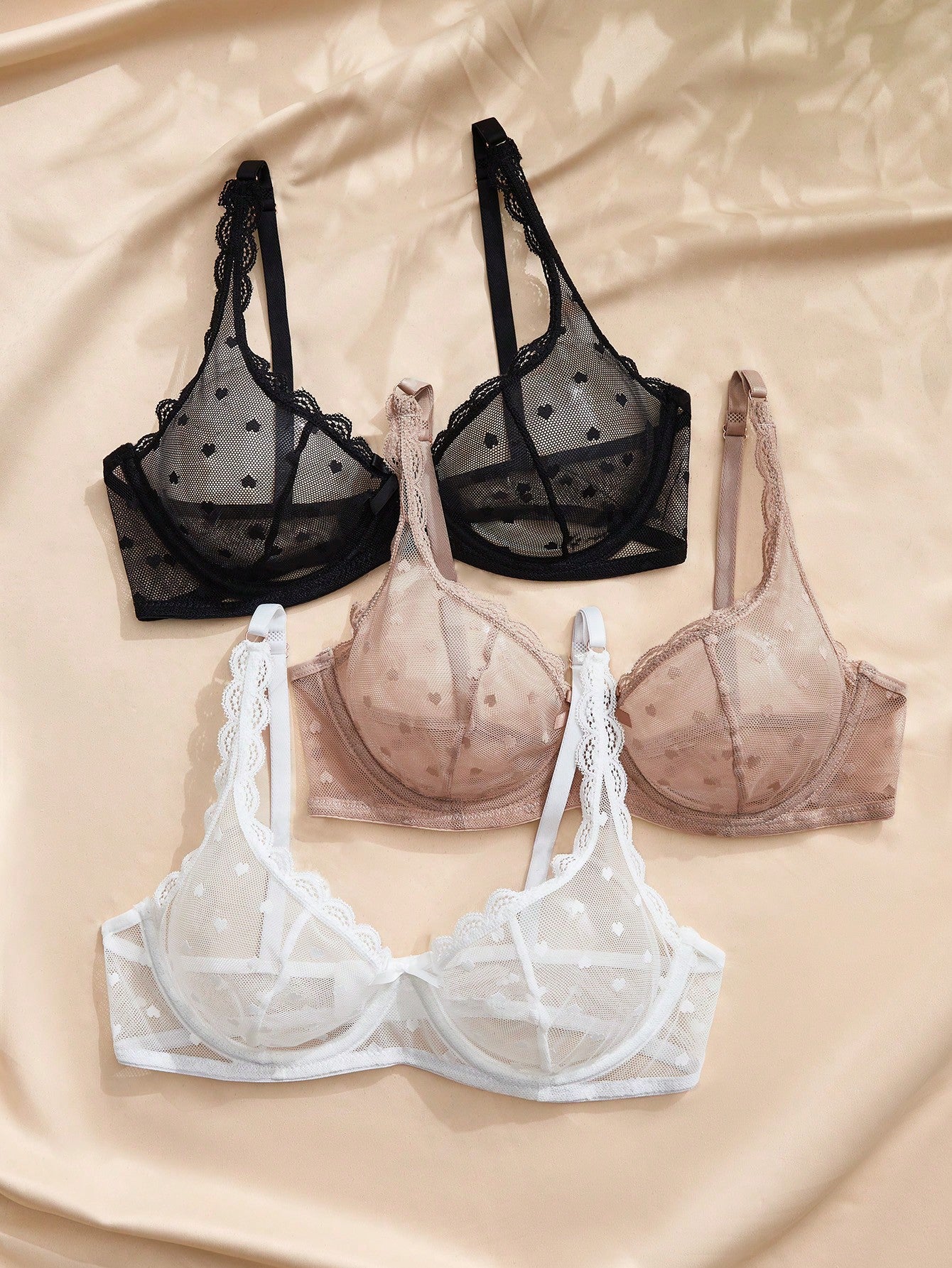 Women's solid color lace bra with sheer unlined design, bow detail, underwire support, and adjustable straps; romantic style push-up bralette for daily wear.