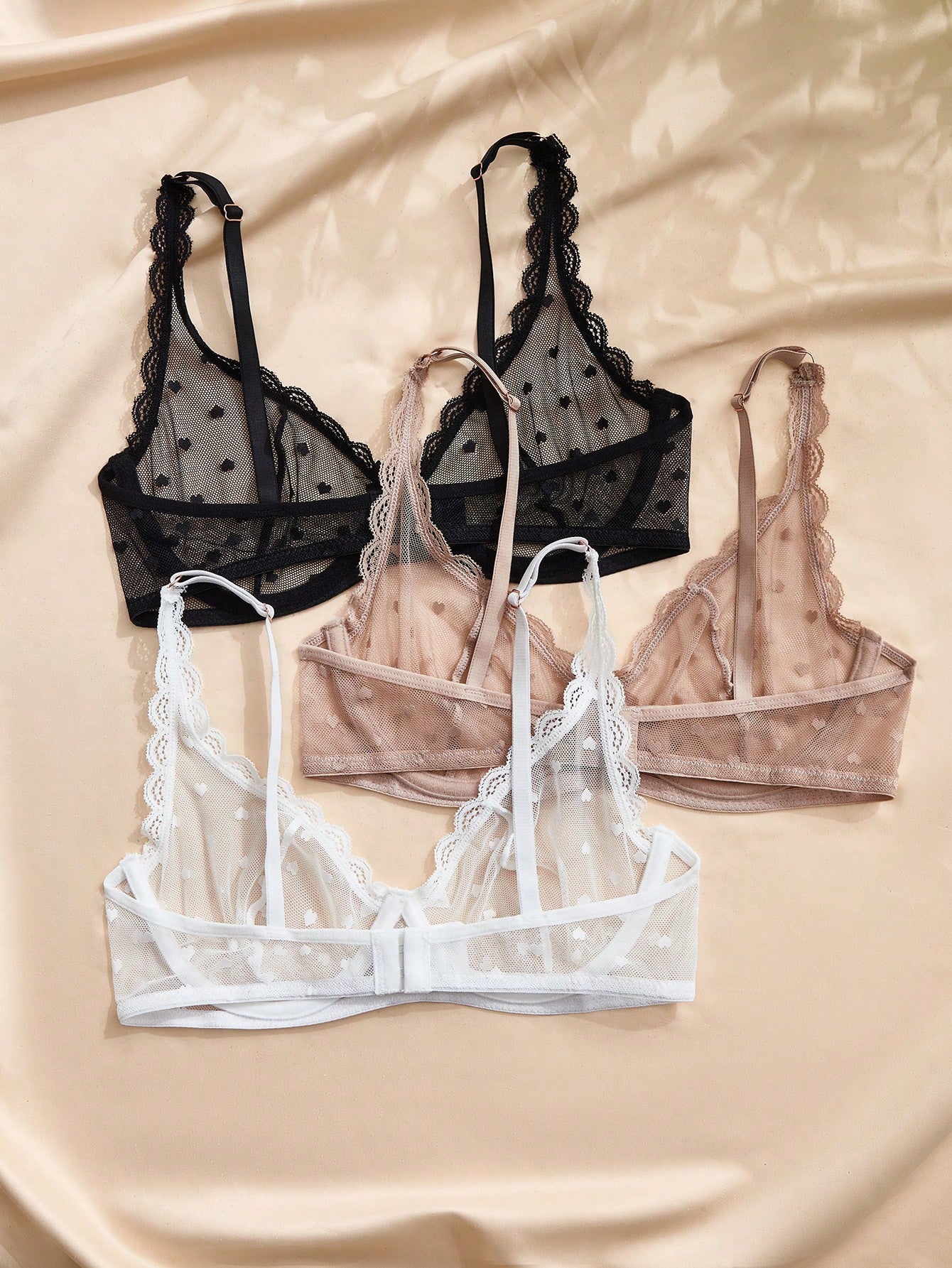 Women's solid color lace bra with sheer unlined design, bow detail, underwire support, and adjustable straps; romantic style push-up bralette for daily wear.