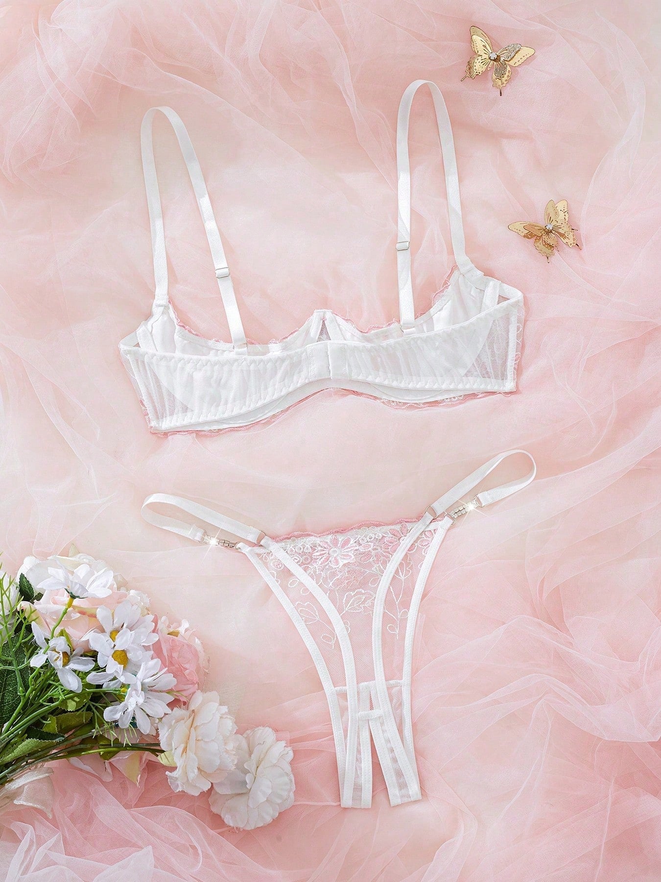 Light pink and white embroidered two-piece lingerie set with underwire 1/2 cup bra and matching panty