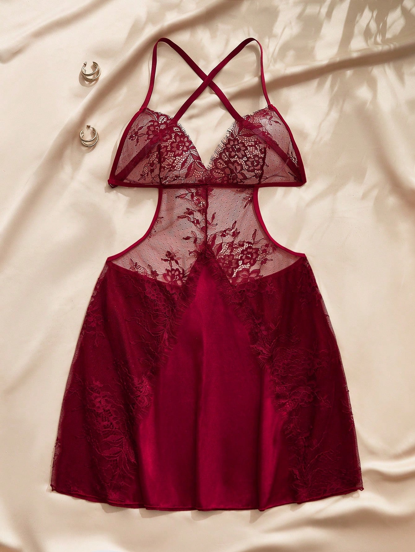 Burgundy women's babydoll nightgown with floral lace, spaghetti straps, backless detail, semi-sheer contrast lace, and mini sleeveless satin-style design