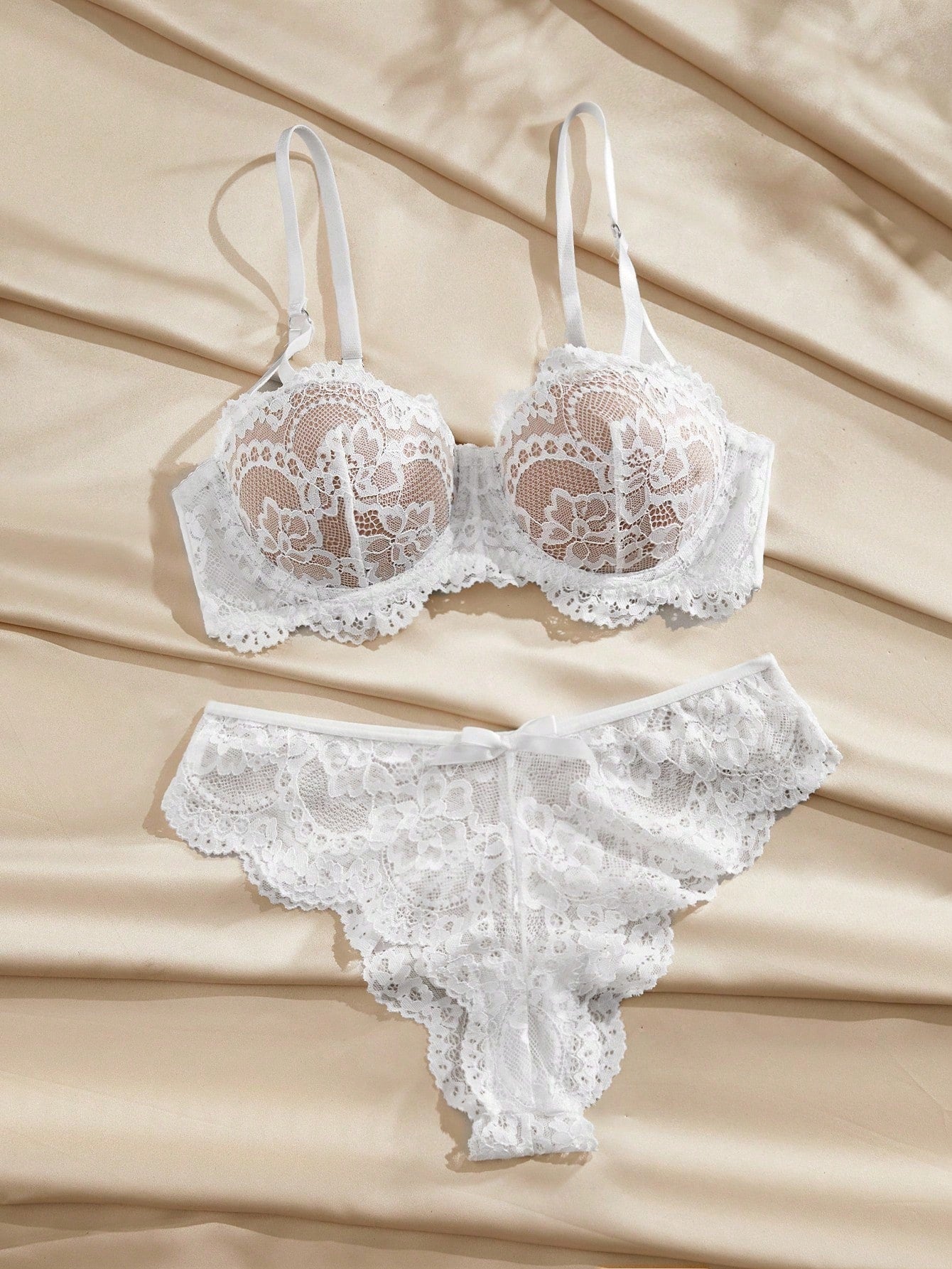 Women's floral lace lingerie set with underwire bra, adjustable straps, scalloped lace details, and matching low-rise brief panty