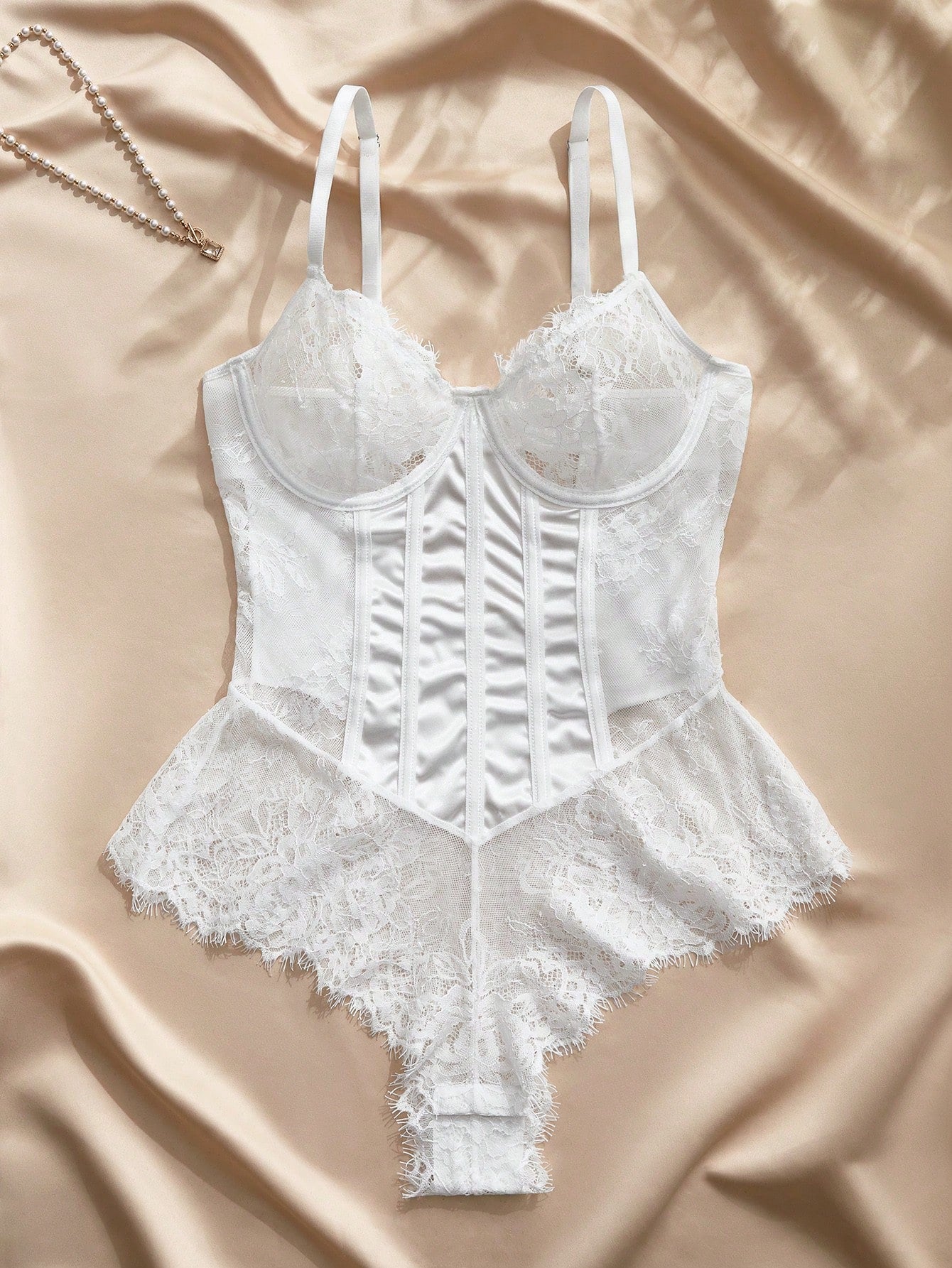 White women's underwire lace lingerie bodysuit with contrast lace details, sleeveless styling, brief coverage, and a backless design