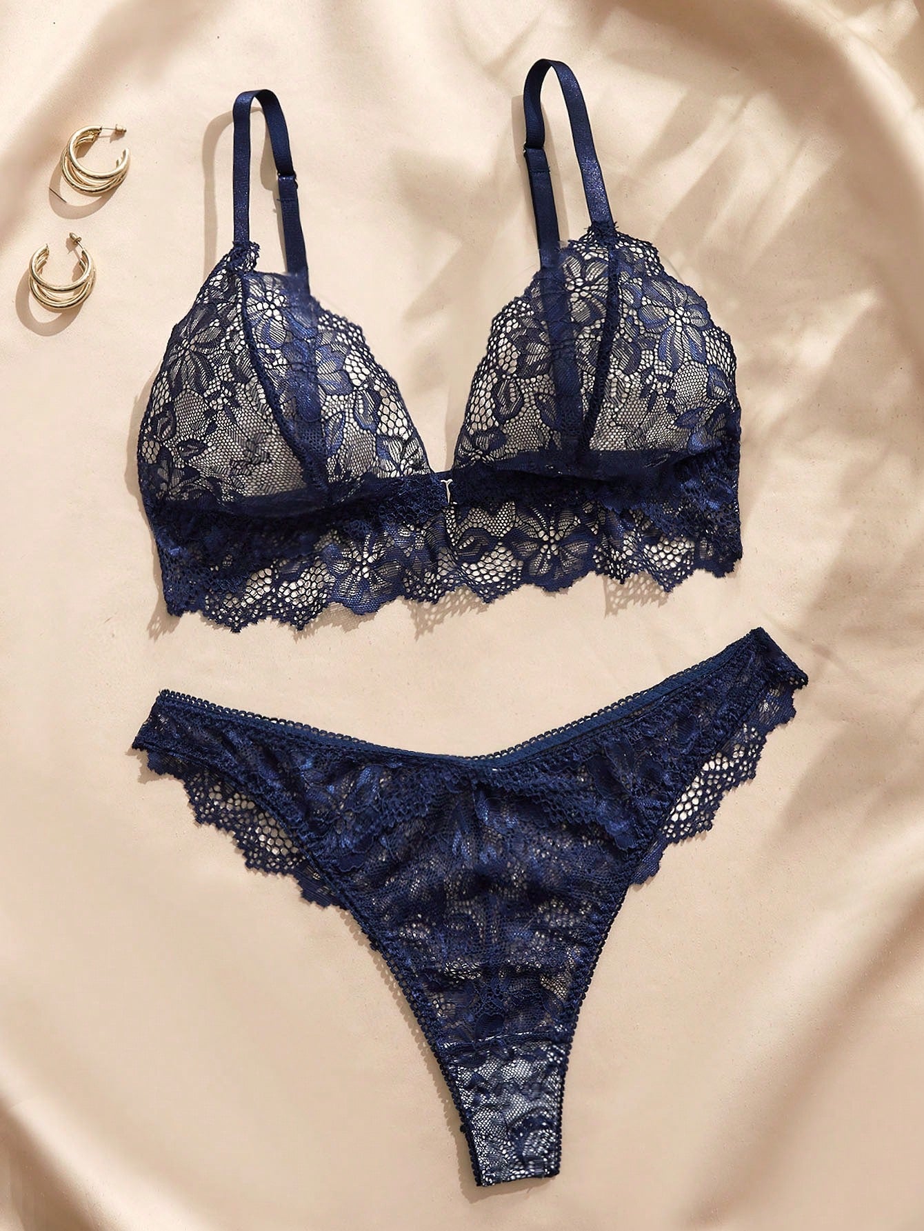 Navy blue floral lace 2-piece lingerie set with wireless triangle bra, adjustable spaghetti straps, sheer lace details, and matching mid-rise thong.
