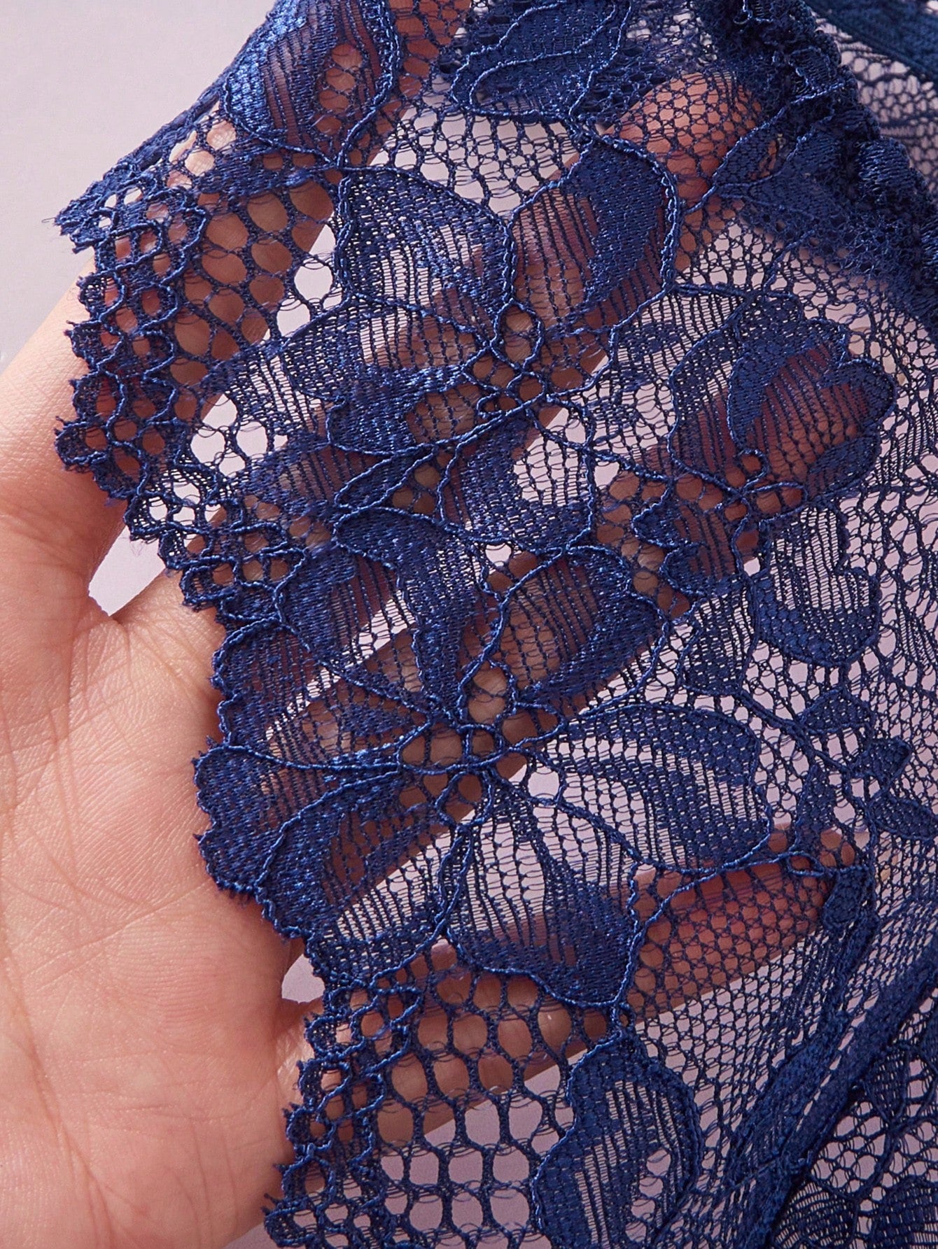 Navy blue floral lace 2-piece lingerie set with wireless triangle bra, adjustable spaghetti straps, sheer lace details, and matching mid-rise thong.
