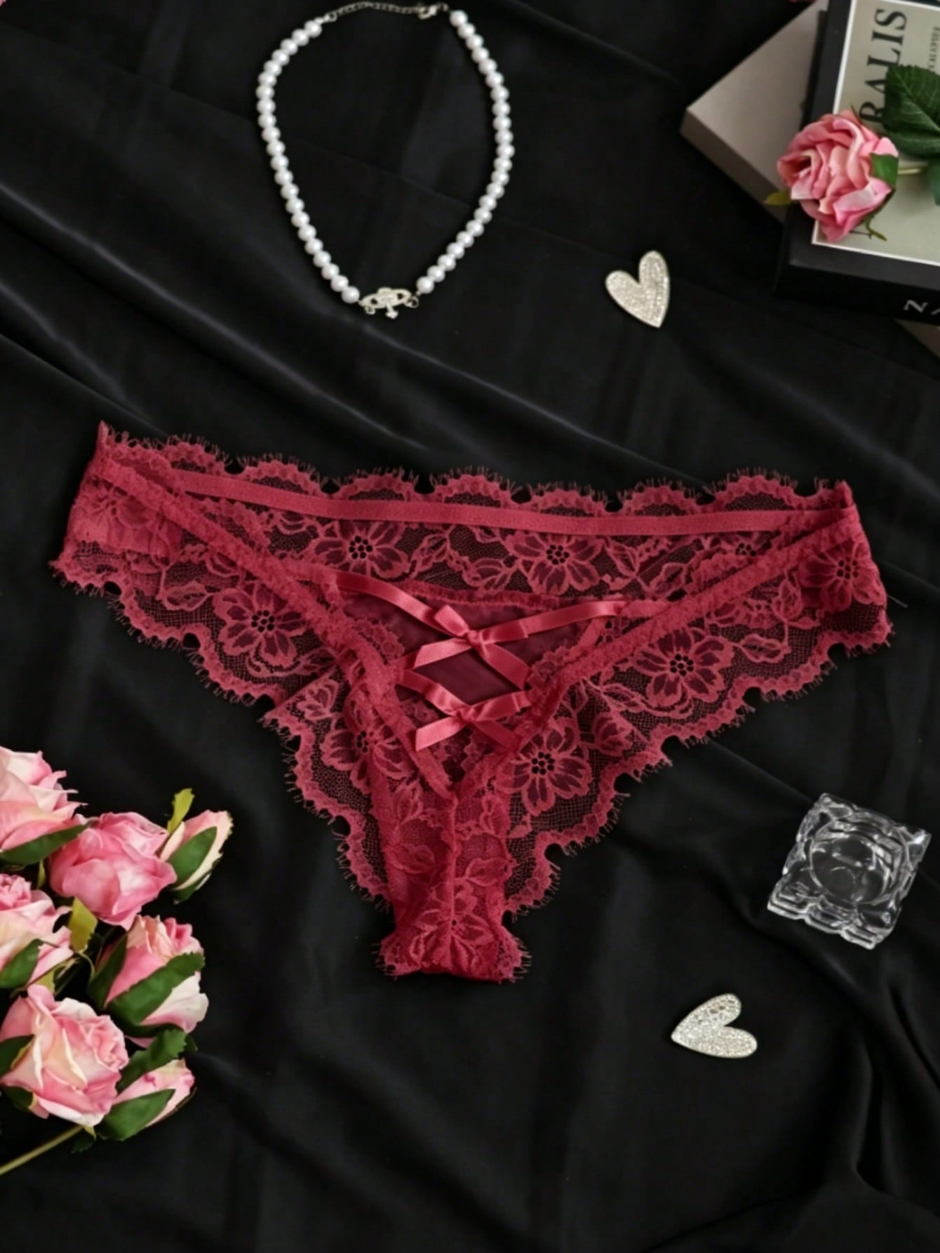 Women's low-rise lace mesh trim thong panties with sheer detailing, bow and knot accents, and plant pattern