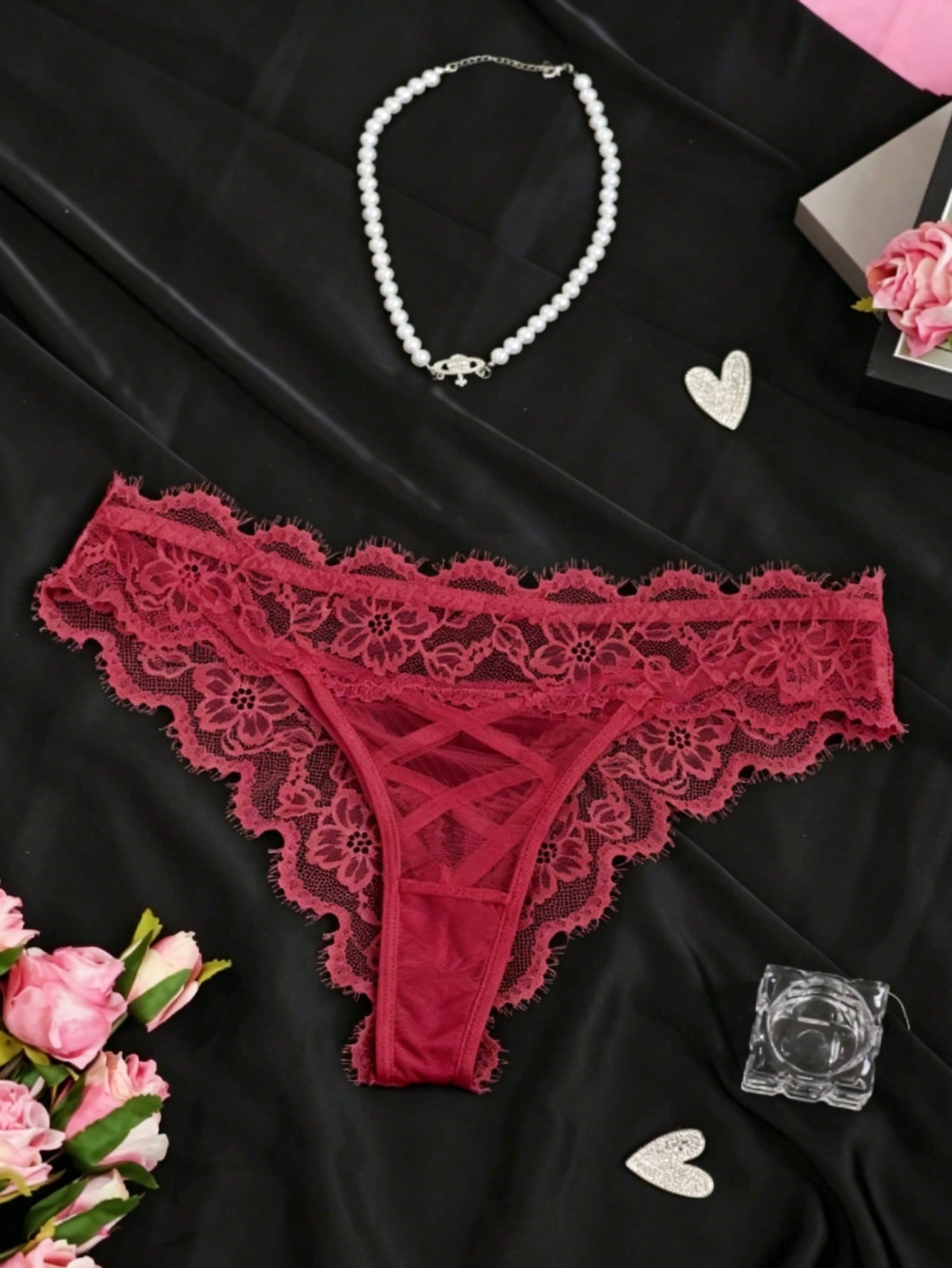 Women's low-rise lace mesh trim thong panties with sheer detailing, bow and knot accents, and plant pattern