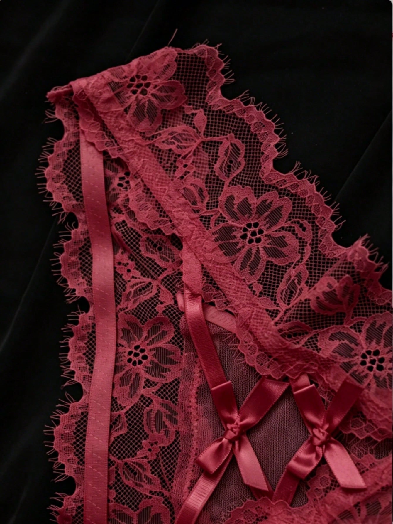 Women's low-rise lace mesh trim thong panties with sheer detailing, bow and knot accents, and plant pattern